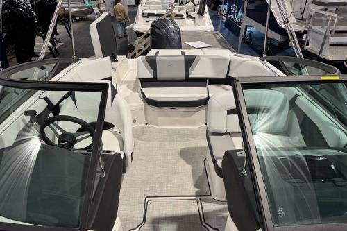 2026 Regal 21 OBX boat interior with seating and steering wheel, showcased at a boat exhibition.