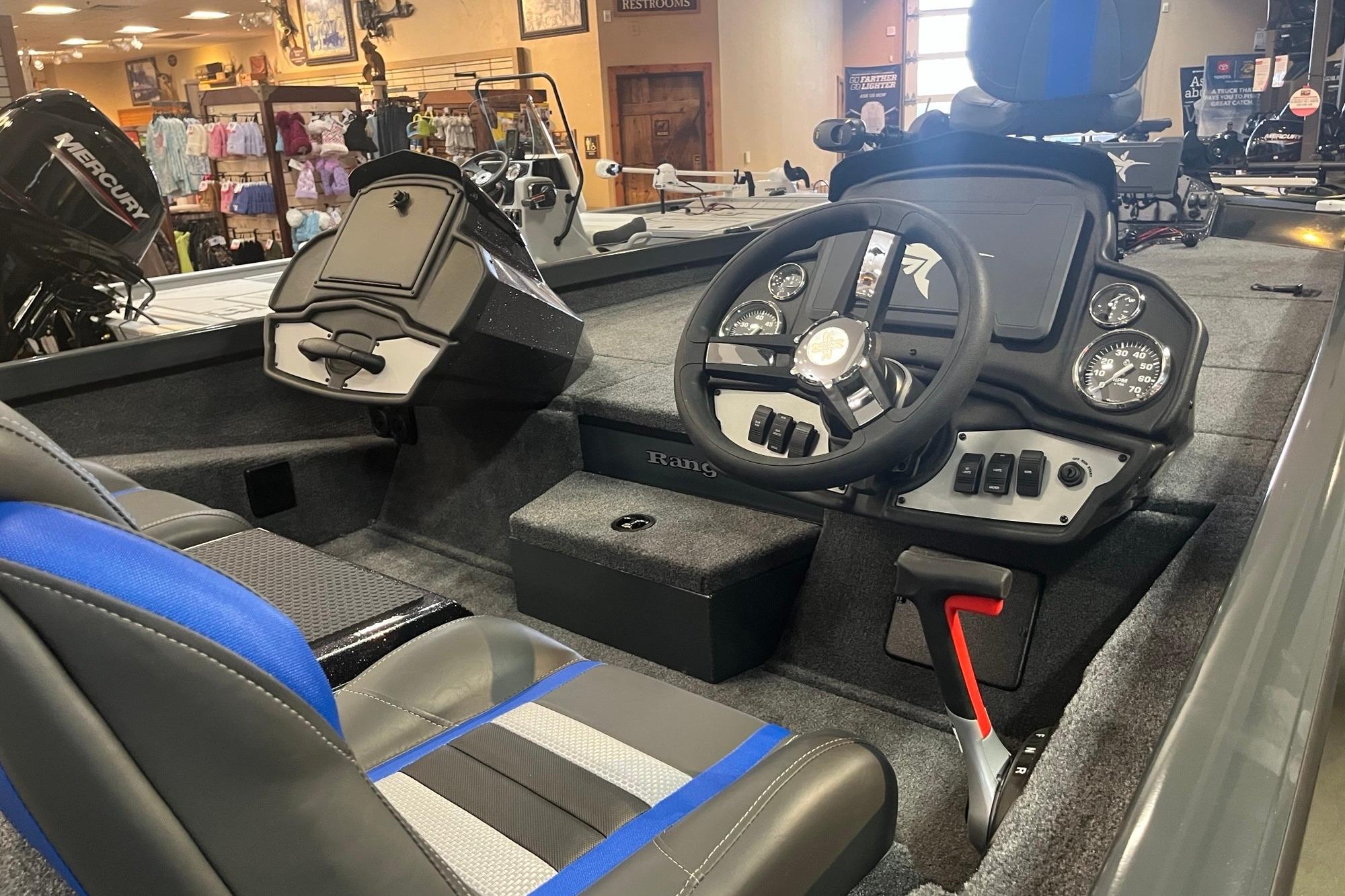 2026 Ranger RT198P boat interior with steering wheel, gauges, and seating in showroom.