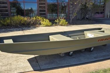 2026 Tracker Grizzly 14 Jon boat displayed outdoors on a sunny day.