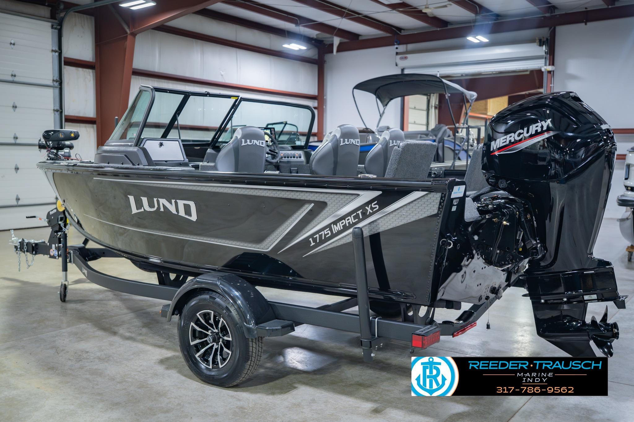 2026 Lund 1775 Impact XS boat in showroom with Mercury engine.