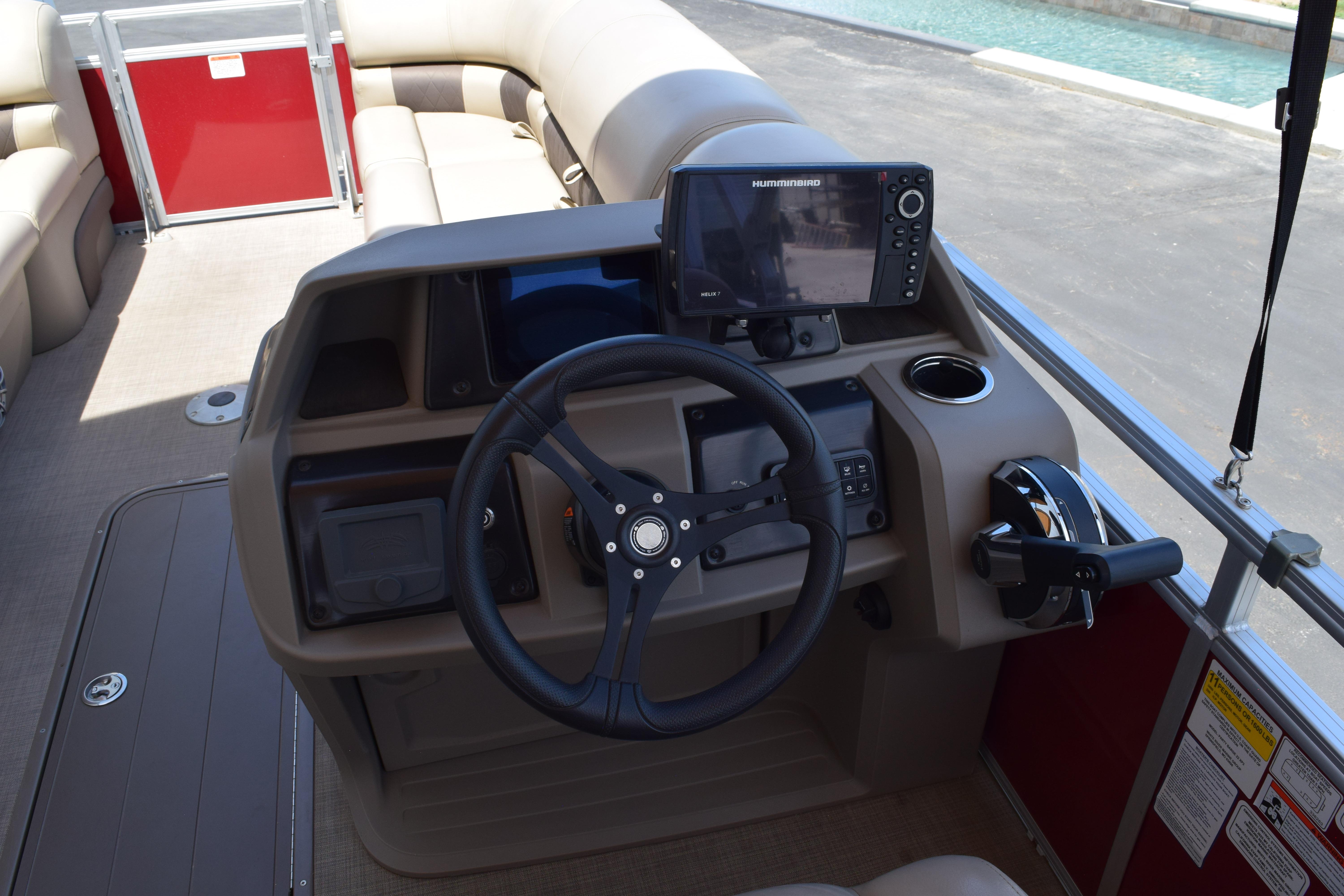 2025 Sun Tracker Party Barge 22 XP3 helm with steering wheel and navigation system.