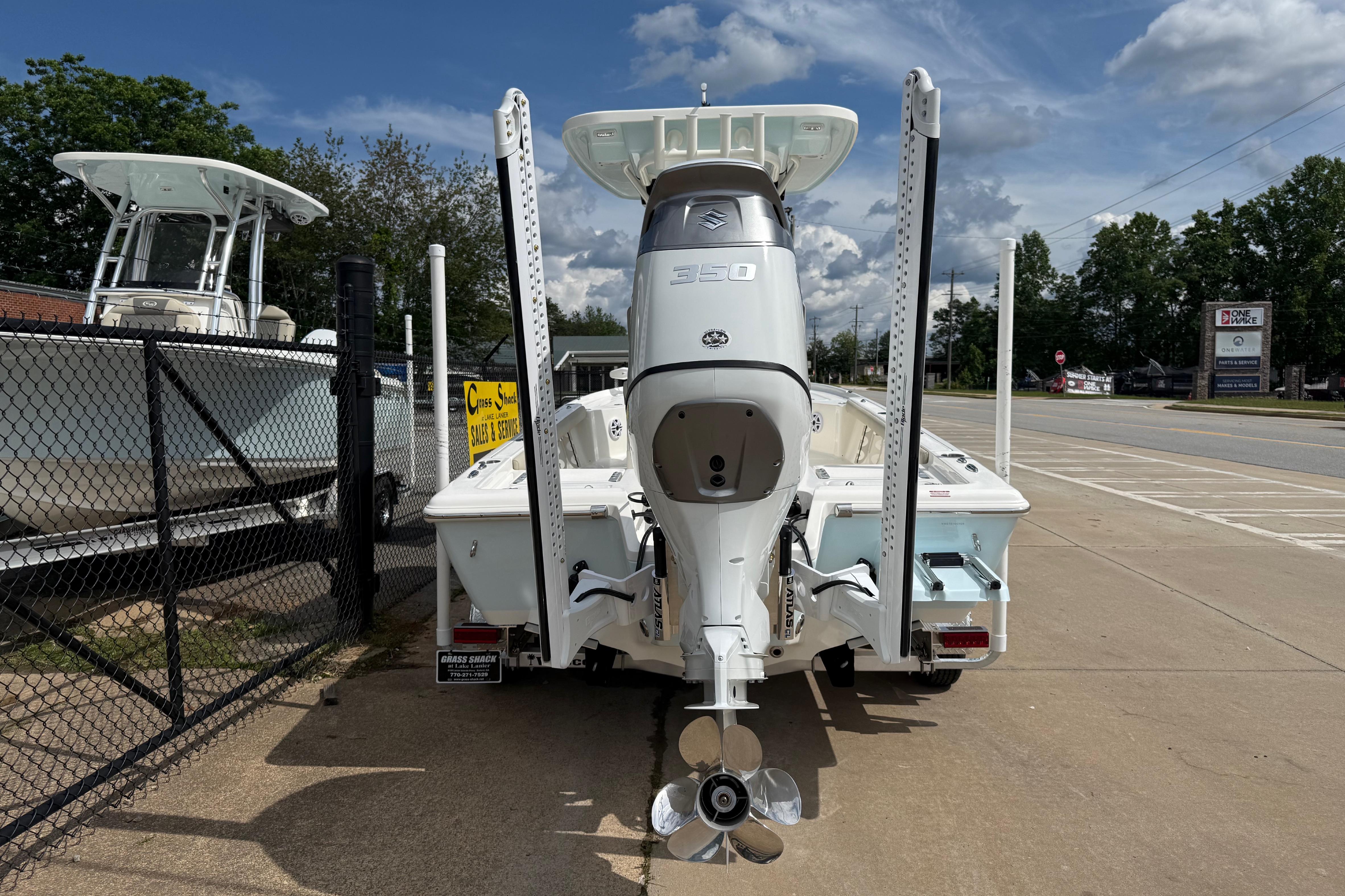 2026 Key West 250 Bay Reef boat with powerful outboard motor, parked outdoors.