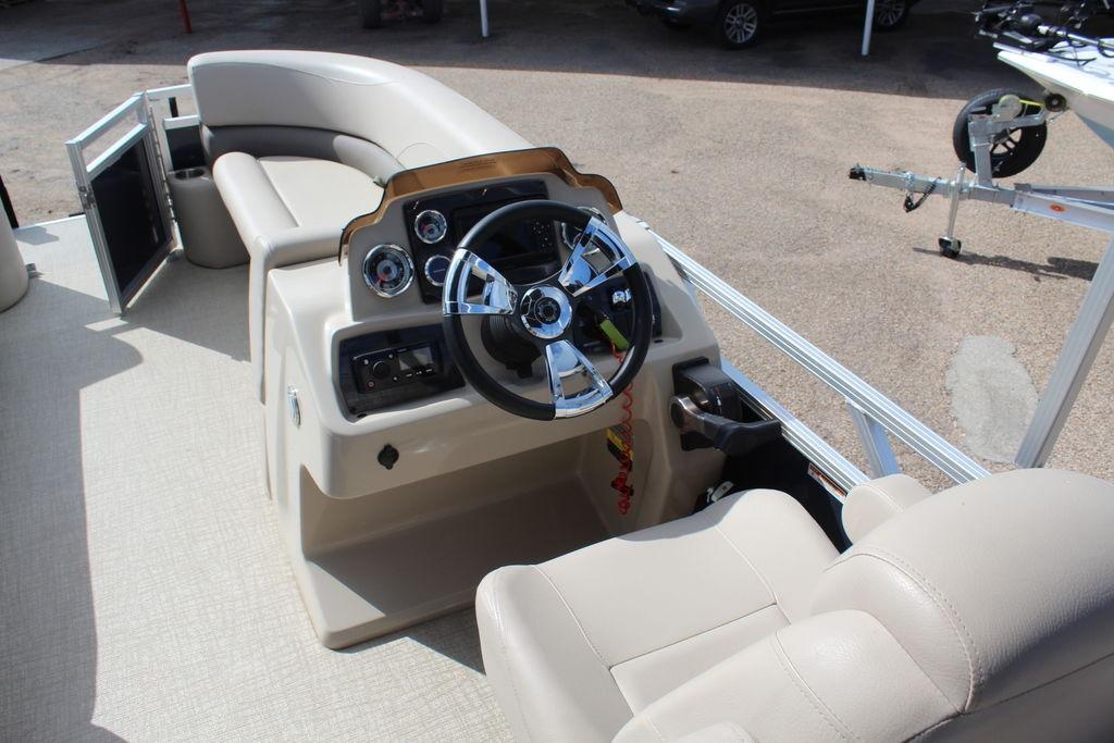 2021 Avalon VLS Quad Lounge 22 FT boat interior with steering console and seating.
