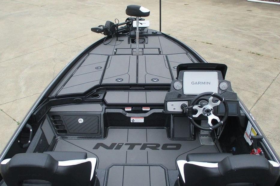 2026 Tracker Pro Guide V-16 WT boat interior with Garmin navigation system and steering wheel.