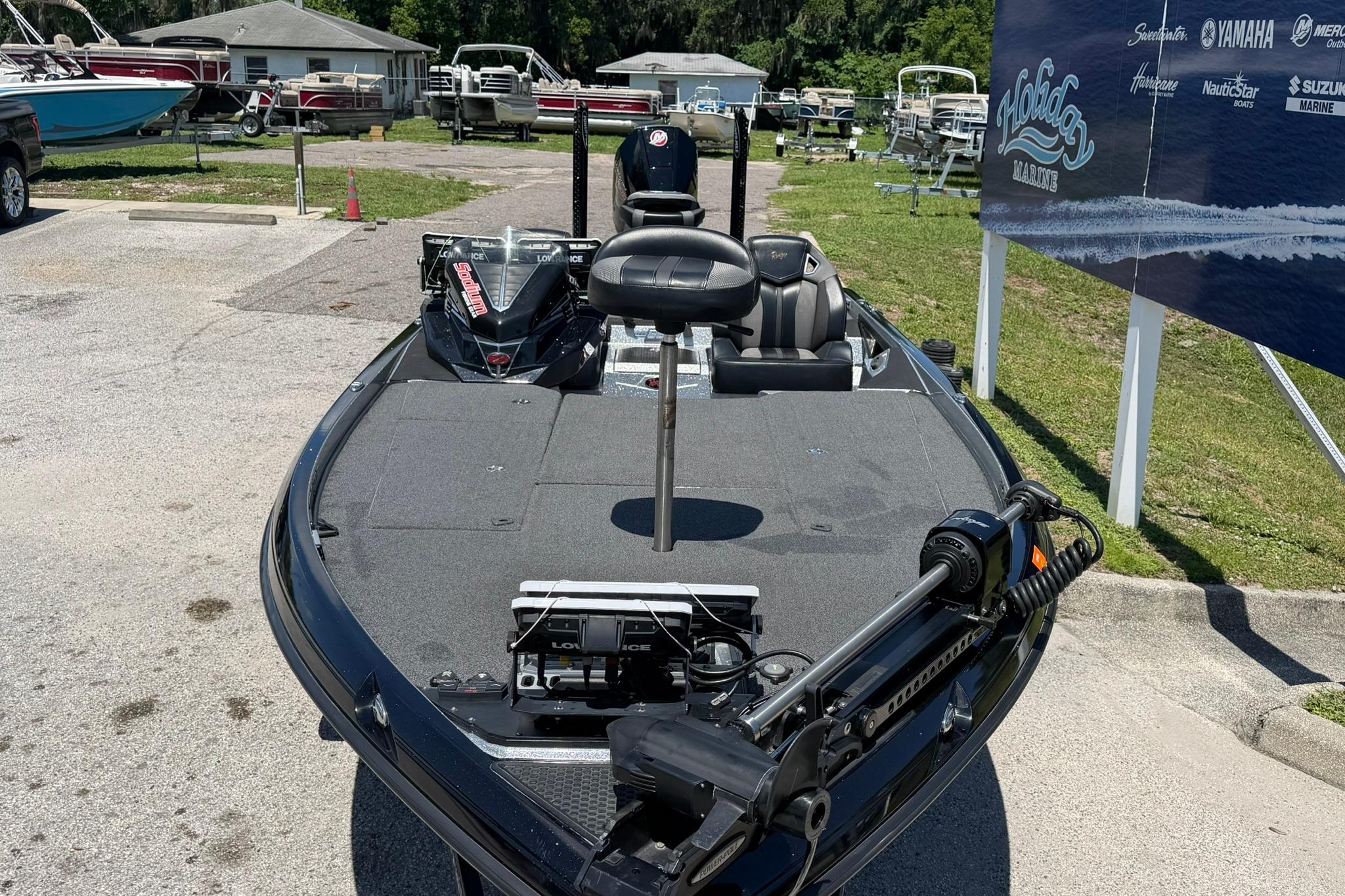 2023 Ranger Z521R bass boat in a marina, showcasing deck and seating.