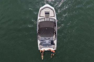 2026 Yamaha Boats AR190 on water, aerial view, two people swimming at stern.