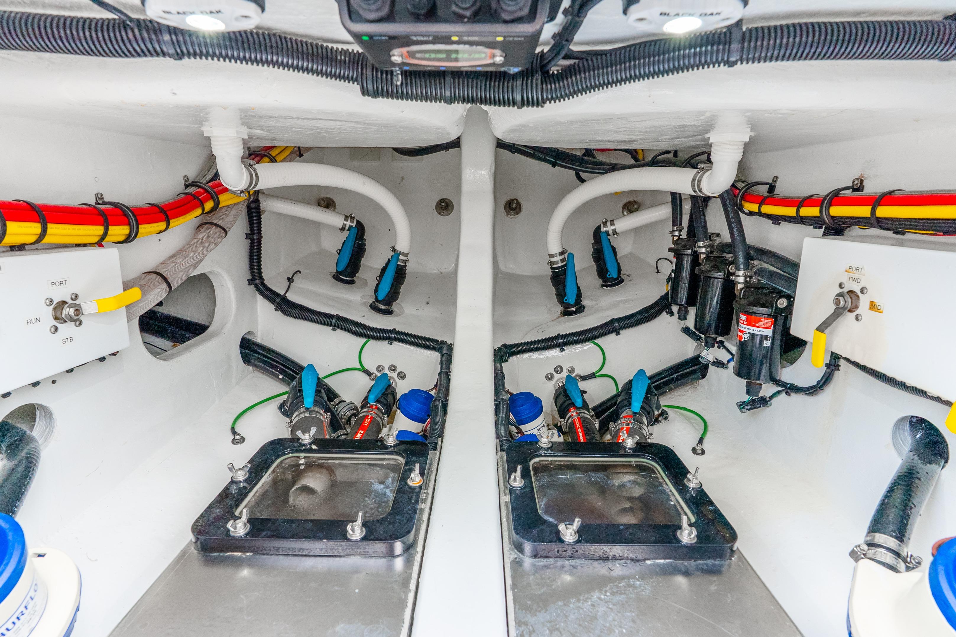 Engine compartment of 2024 Nor-Tech 452 Super Fish, showcasing detailed wiring and plumbing systems.