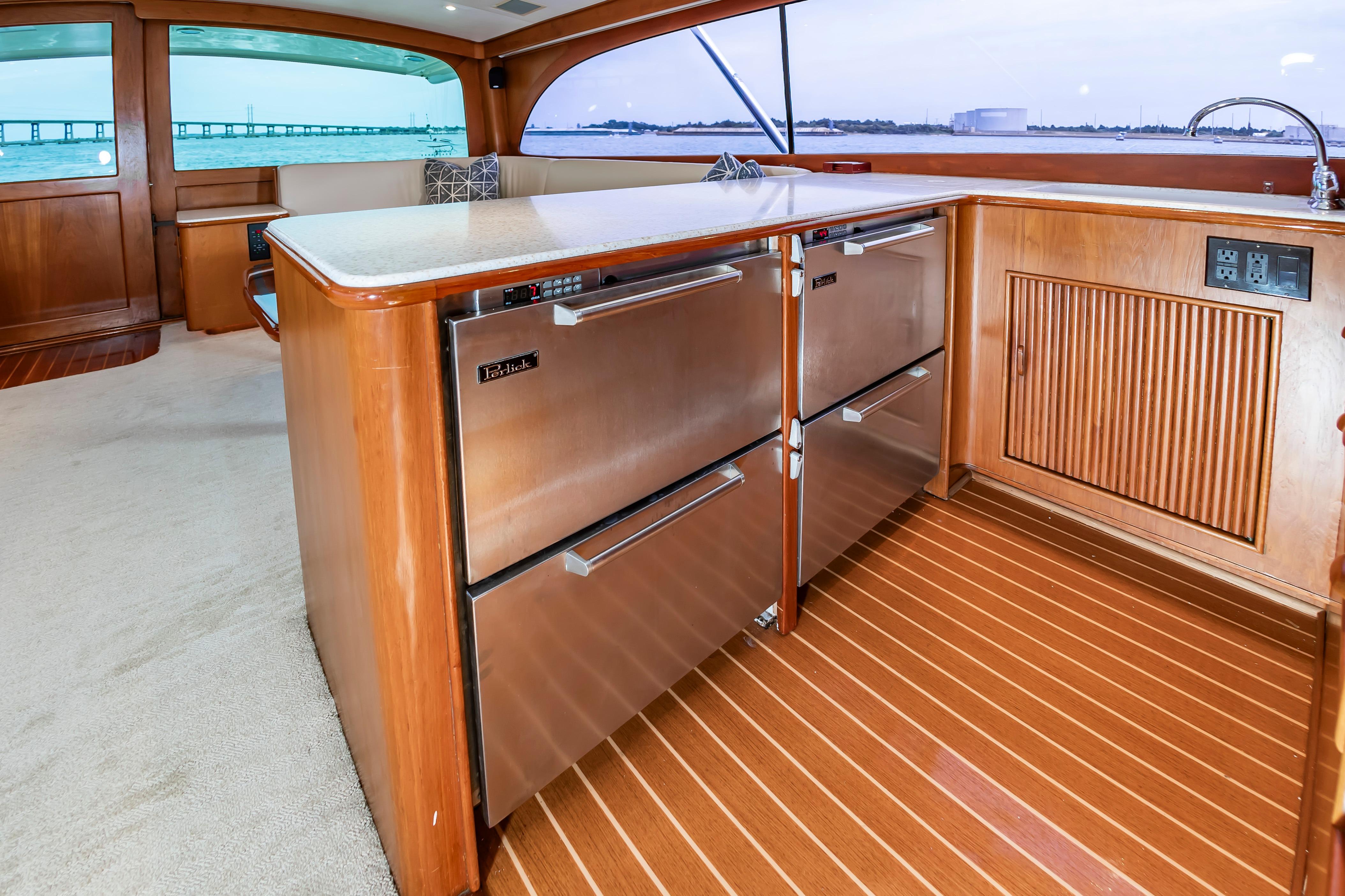 Luxurious interior of 1993 Custom Carolina Scarborough 56 Convertible yacht with modern kitchen amenities.
