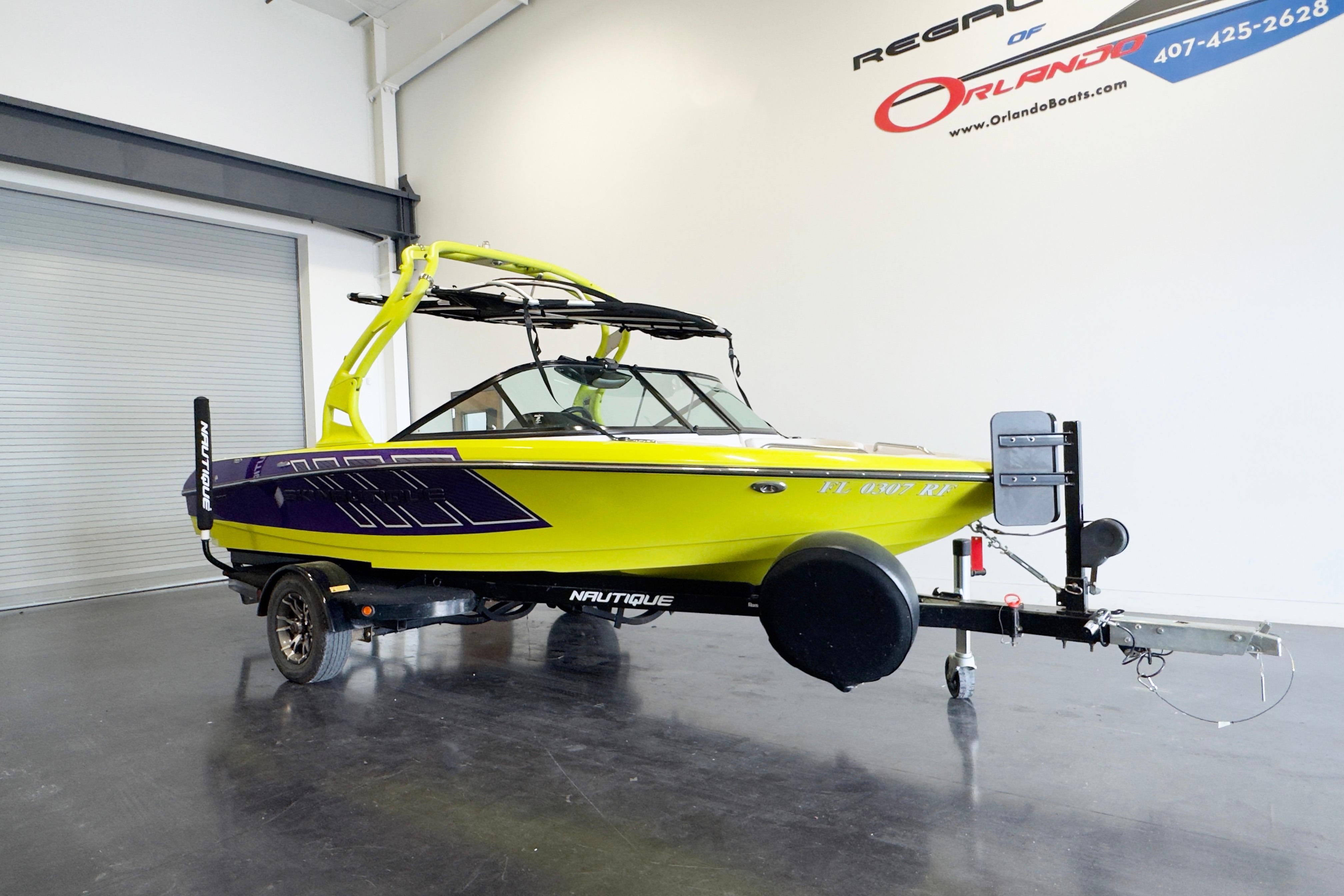 2014 Nautique Ski Nautique 200 Closed Bow boat on trailer in showroom.