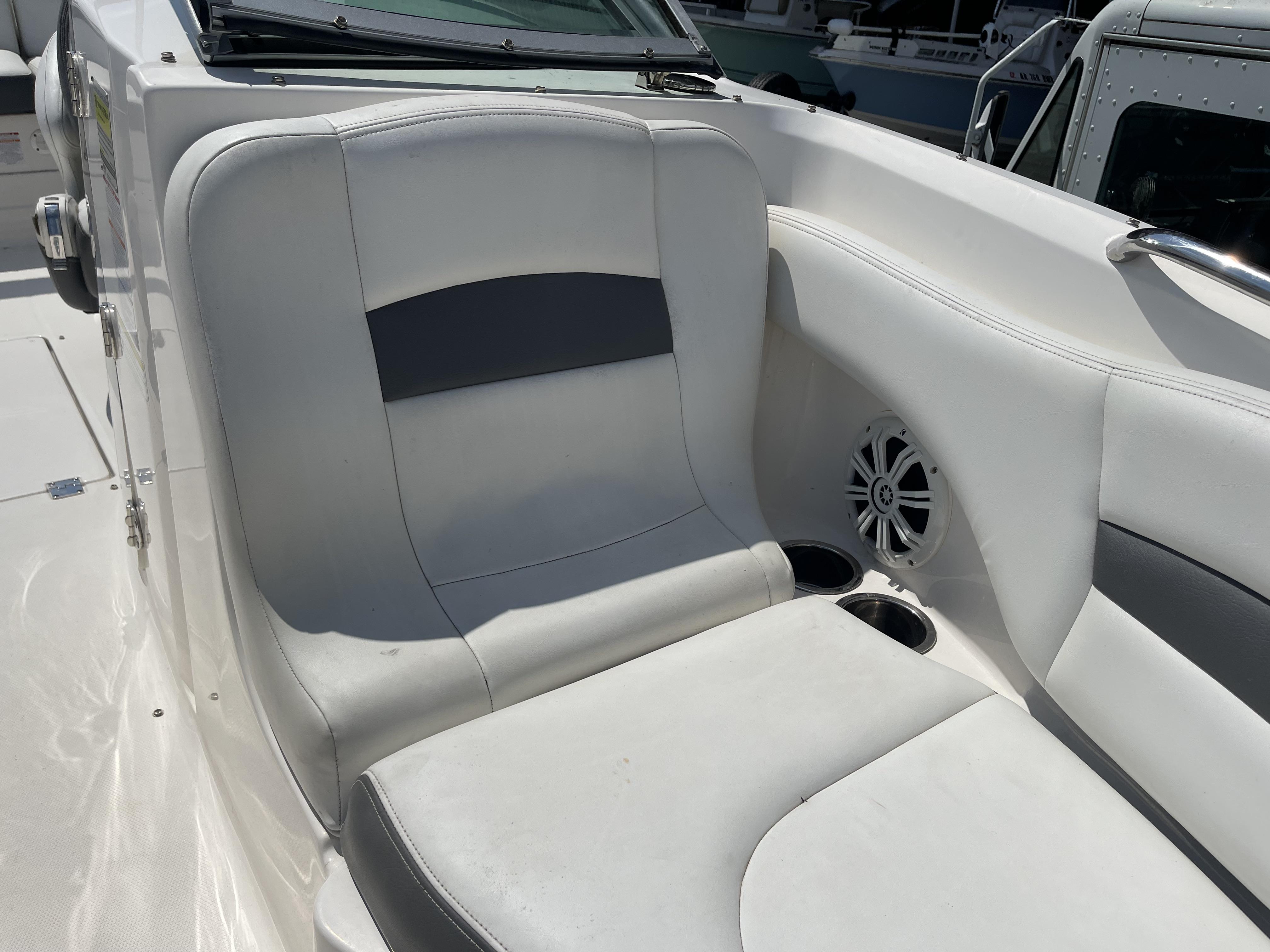 2014 Chaparral Sunesta 224 boat interior with white seating and speaker.