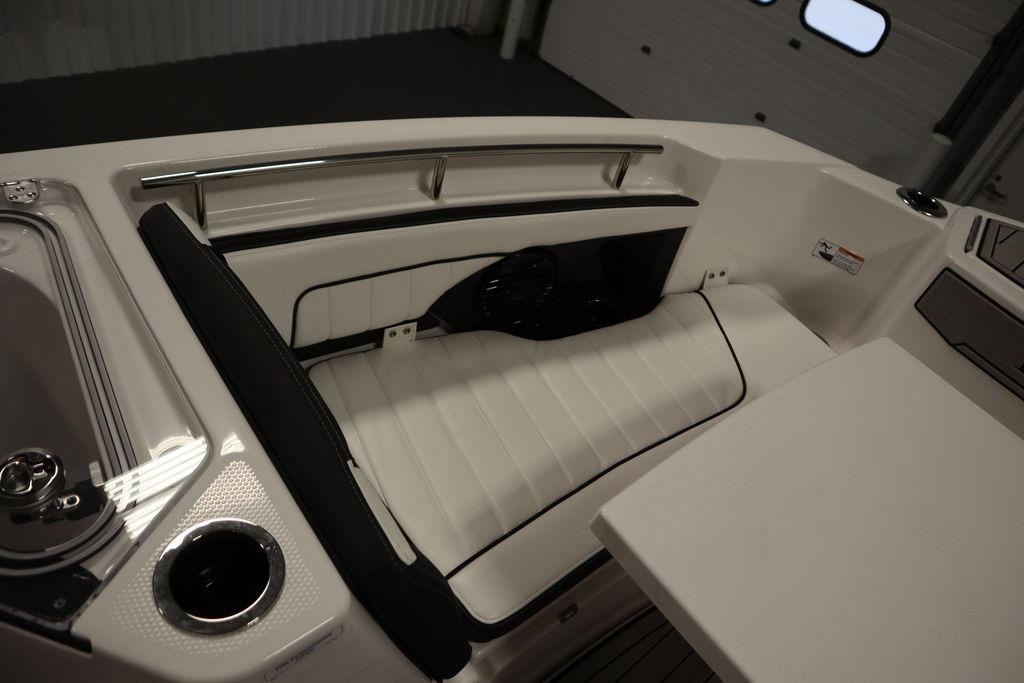 2026 Yamaha Boats 255 FSH Sport E interior seating with sleek white upholstery and stainless steel rail.
