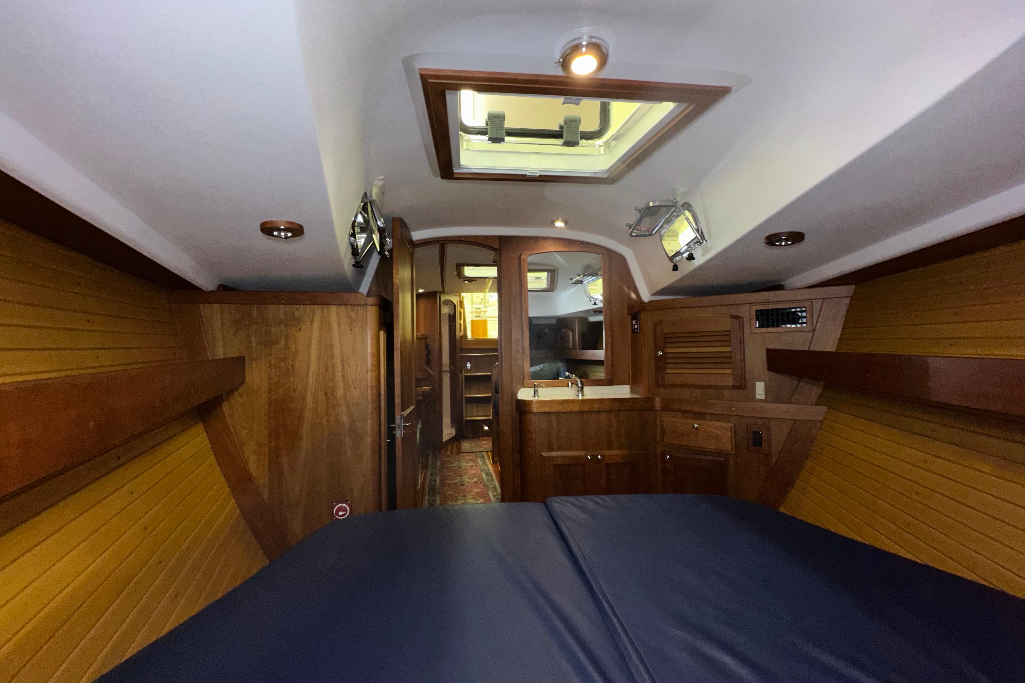Interior of a 2007 Sabre 386 yacht, featuring wood paneling and a skylight.