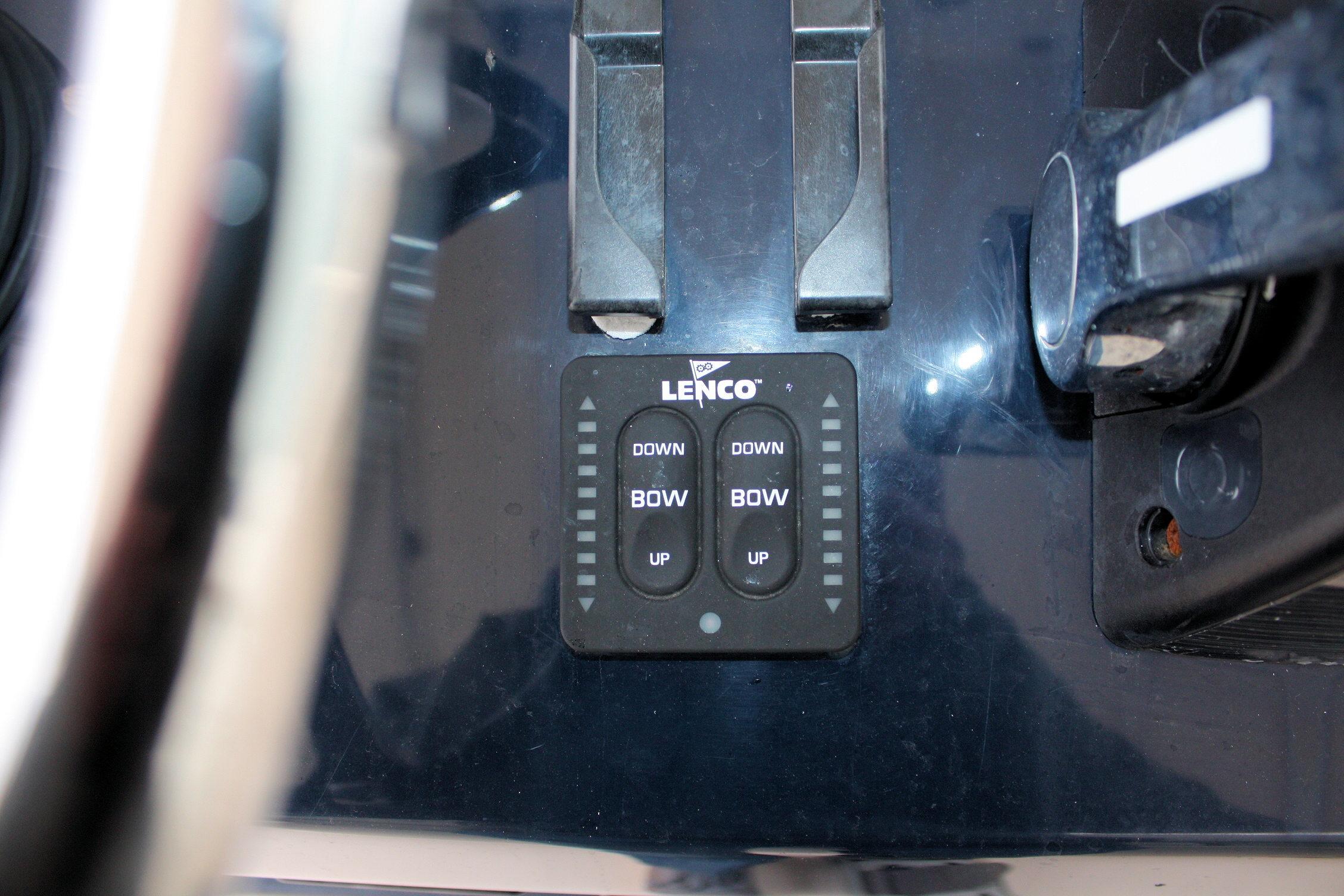 Control panel of a 2013 Pursuit ST 310 Sport boat with Lenco trim tab switches.