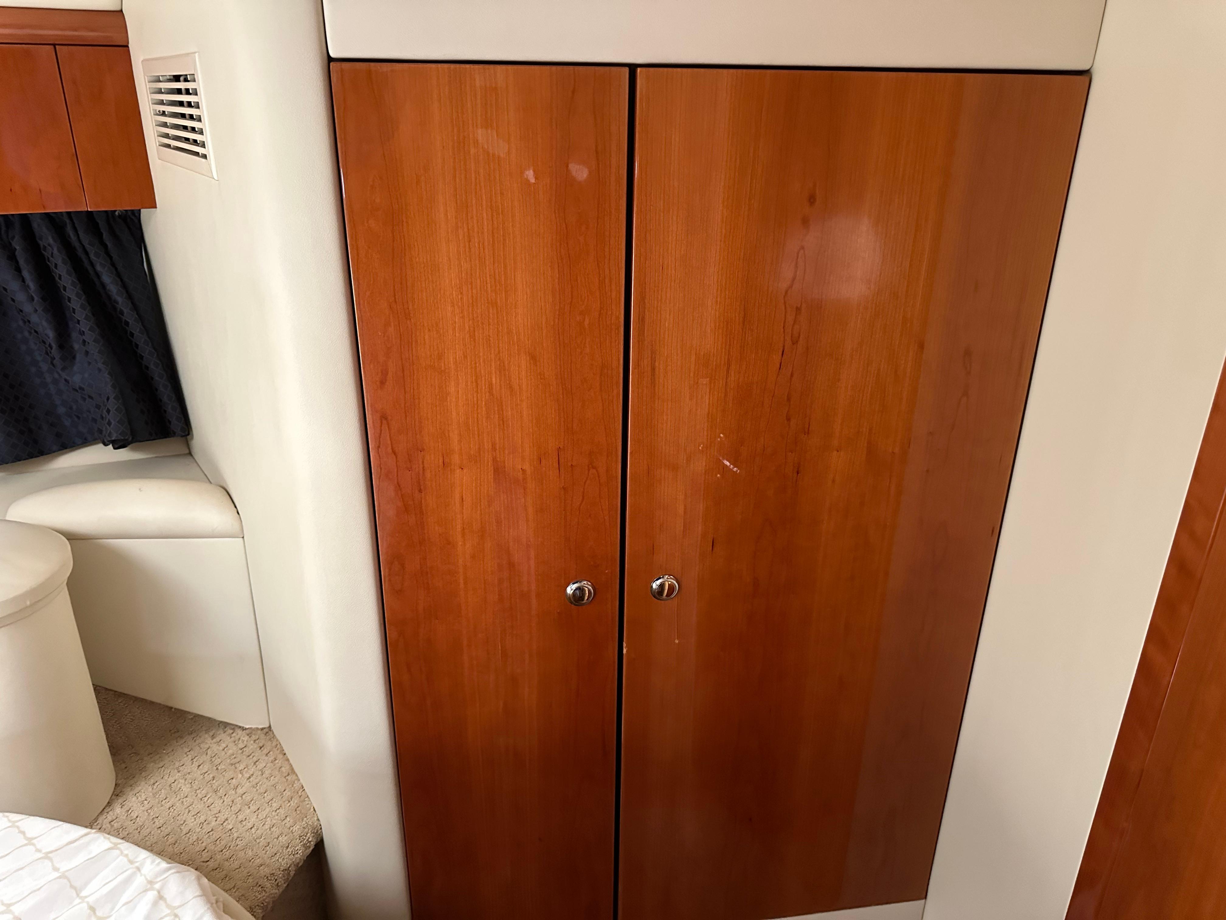 Interior of 1997 Sunseeker Camargue 47 with wooden cabinet and seating area.