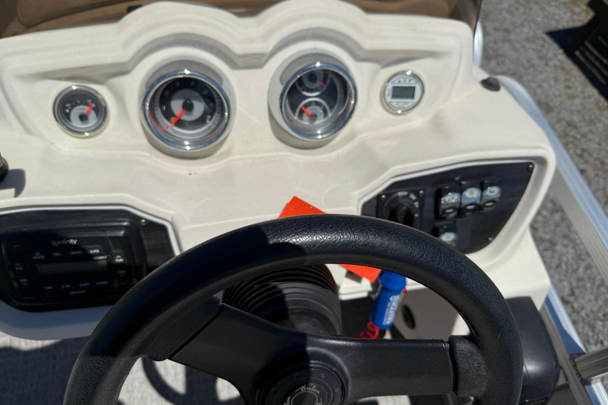 Steering console of 2019 Avalon GS Quad Lounge boat with gauges and controls.