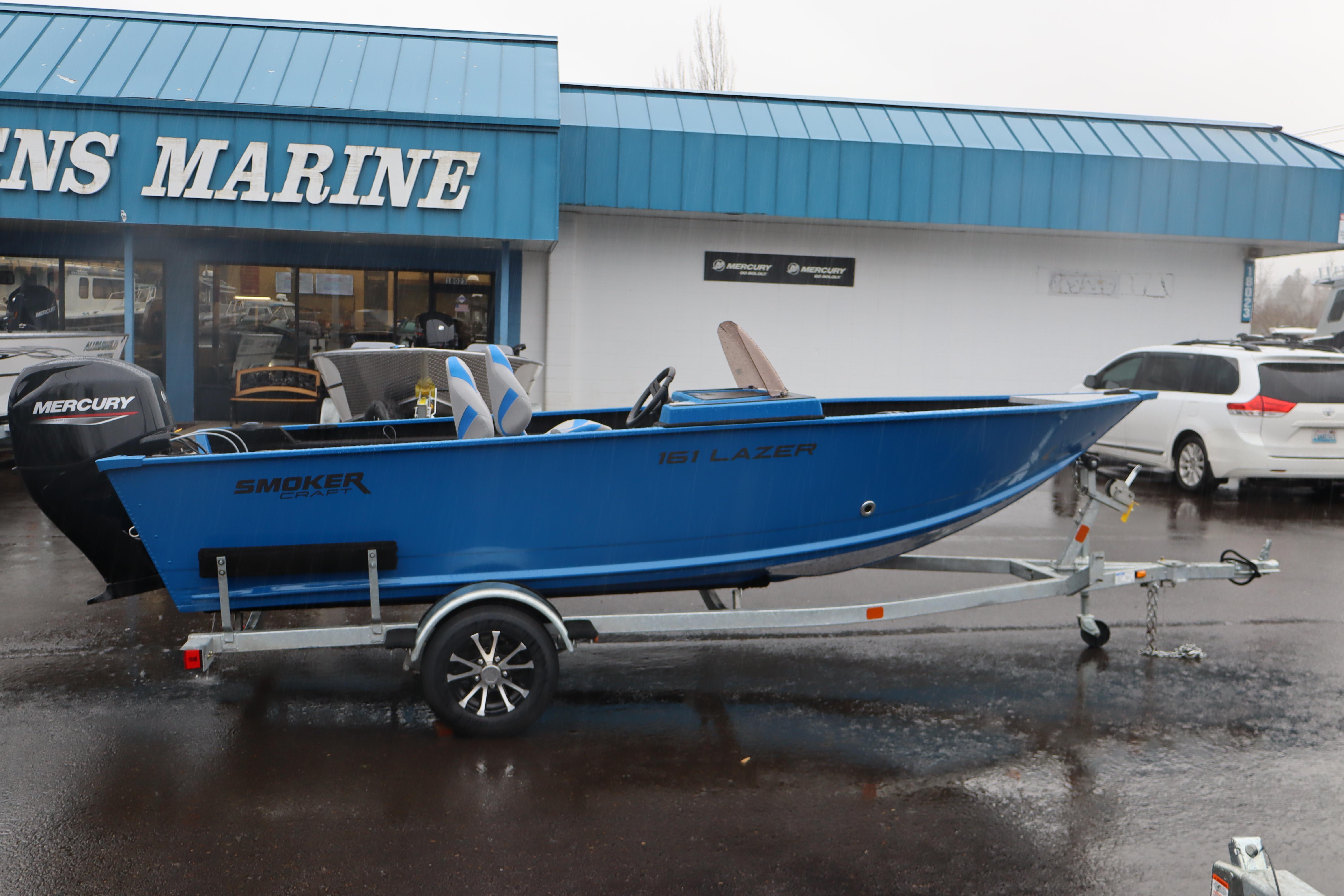 2026 Smoker Craft Lazer 161 boat on trailer outside dealership.