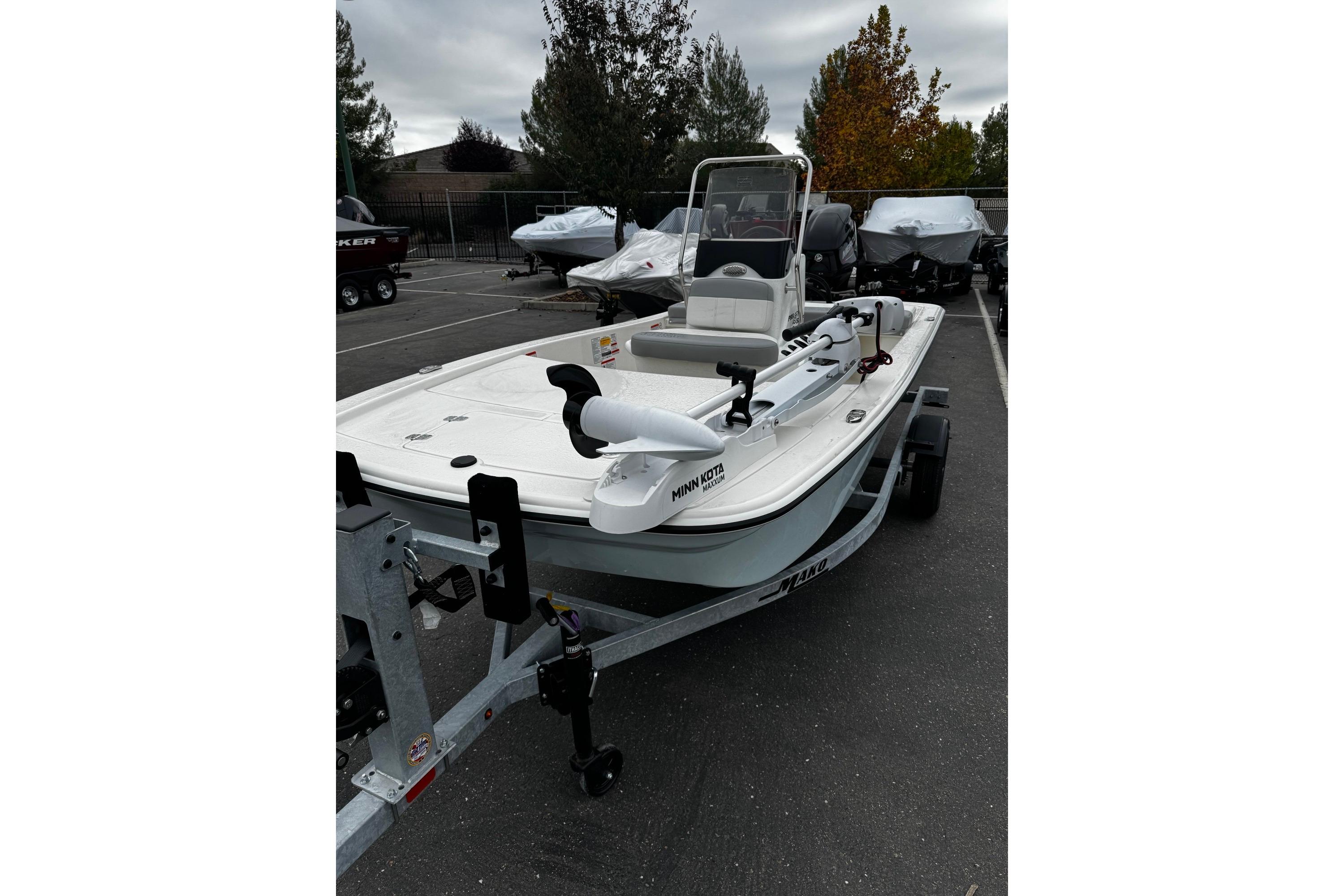 2026 Mako Pro Skiff 13 CC boat on trailer in parking lot.