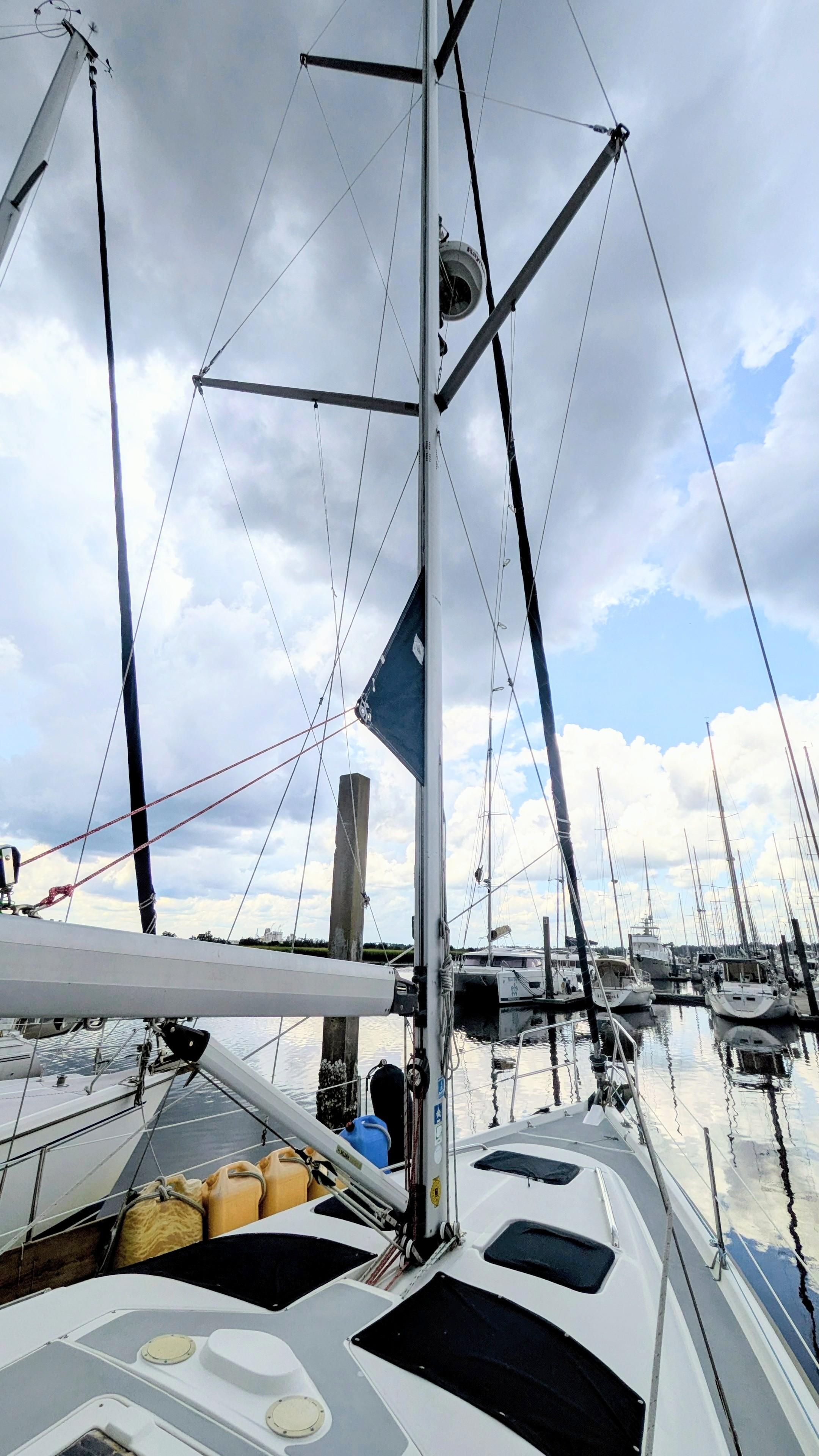 Sailboat Hunter 380, 2001 model, docked at marina under cloudy sky.