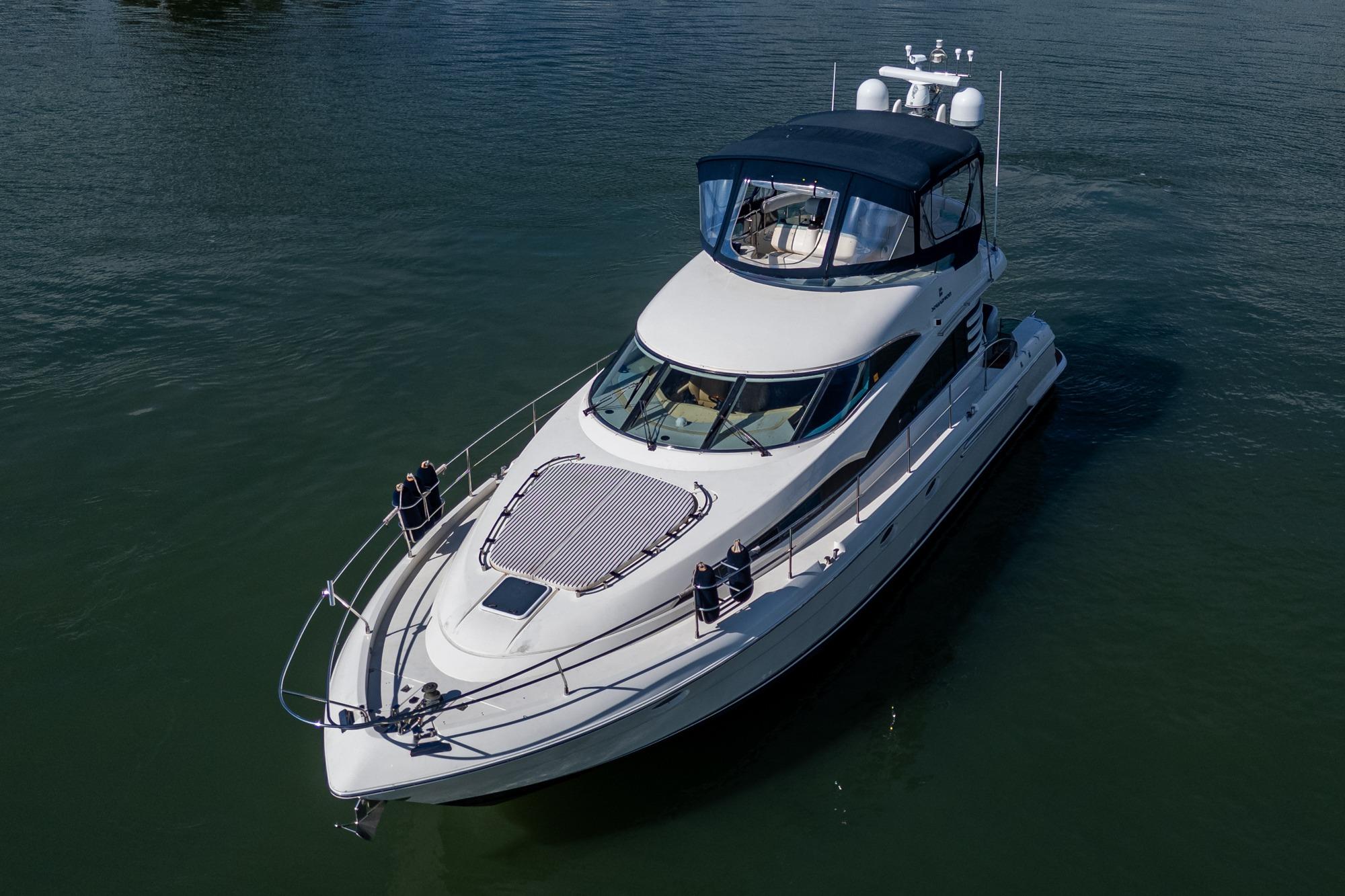 2000 Fairline Squadron 52 yacht cruising on calm waters.