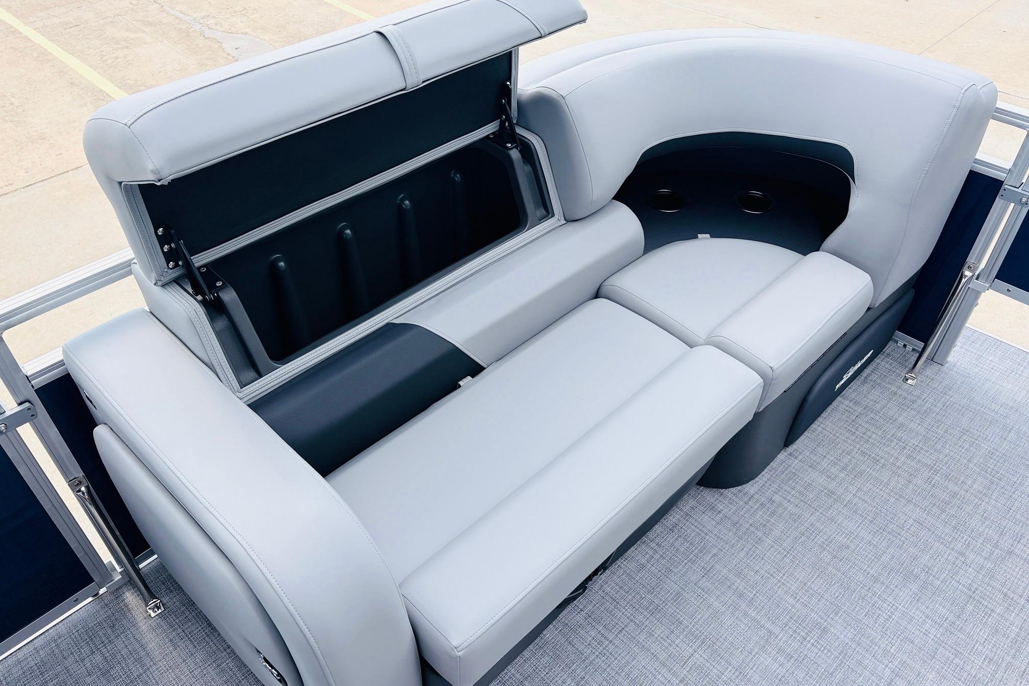 2026 Sun Tracker SportFish 22 DLX boat interior with open storage compartment and cushioned seating.