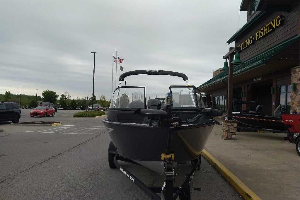 2026 Tracker Pro Guide V-16 WT boat displayed outside a fishing store.