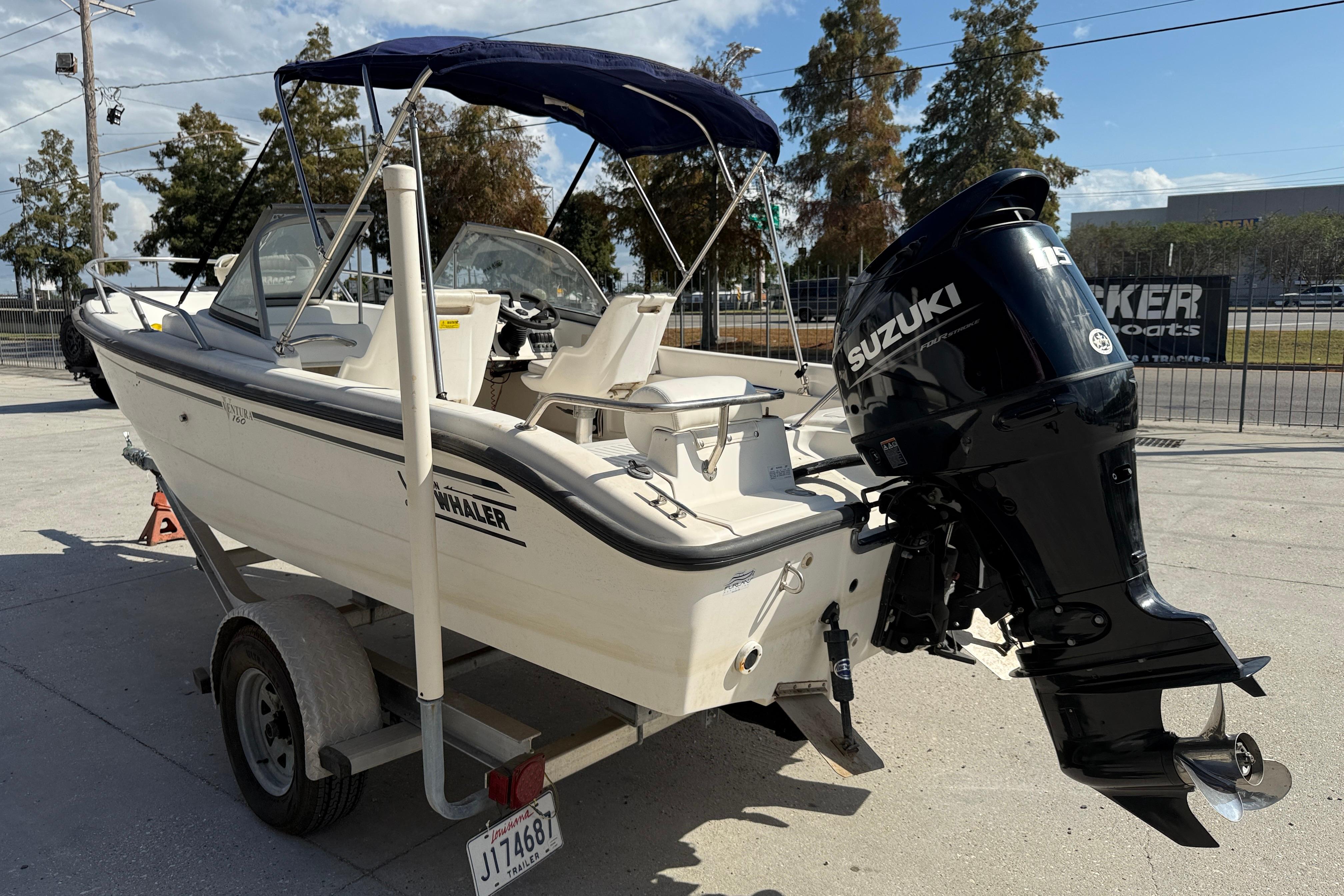 2002 Boston Whaler Ventura 160 boat with Suzuki outboard motor on trailer.