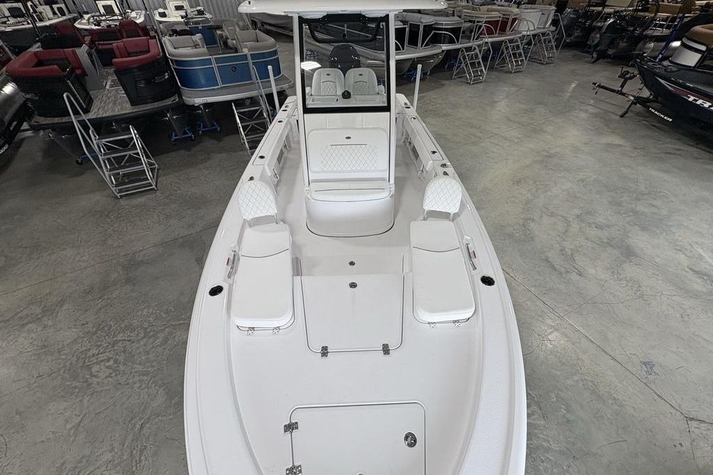 2026 Sportsman Masters 227 boat in showroom, featuring spacious deck and seating.