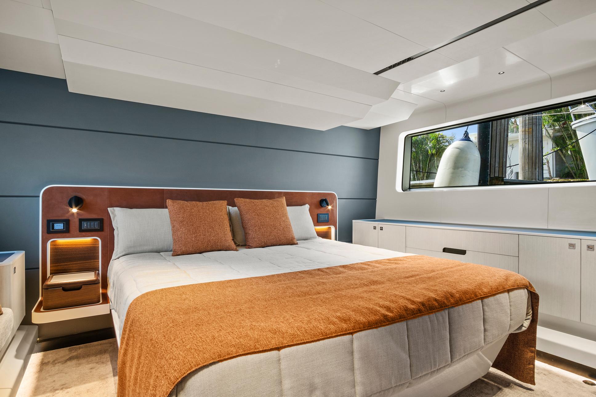 Luxurious 2023 Astondoa AS5 yacht bedroom with modern design and large window.