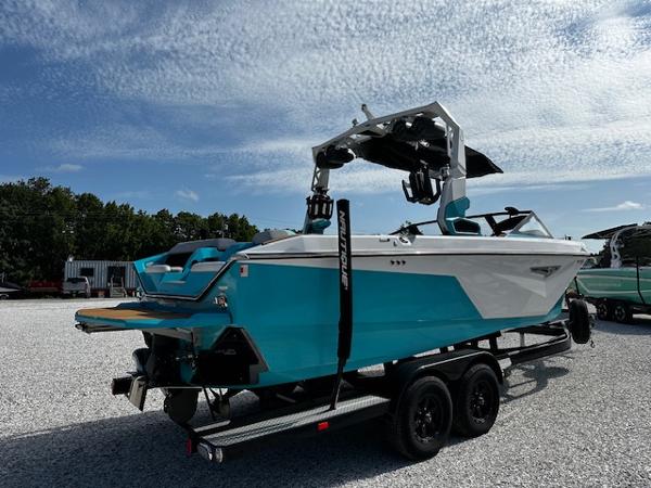 2022 Nautique S23 boat on trailer under blue sky.
