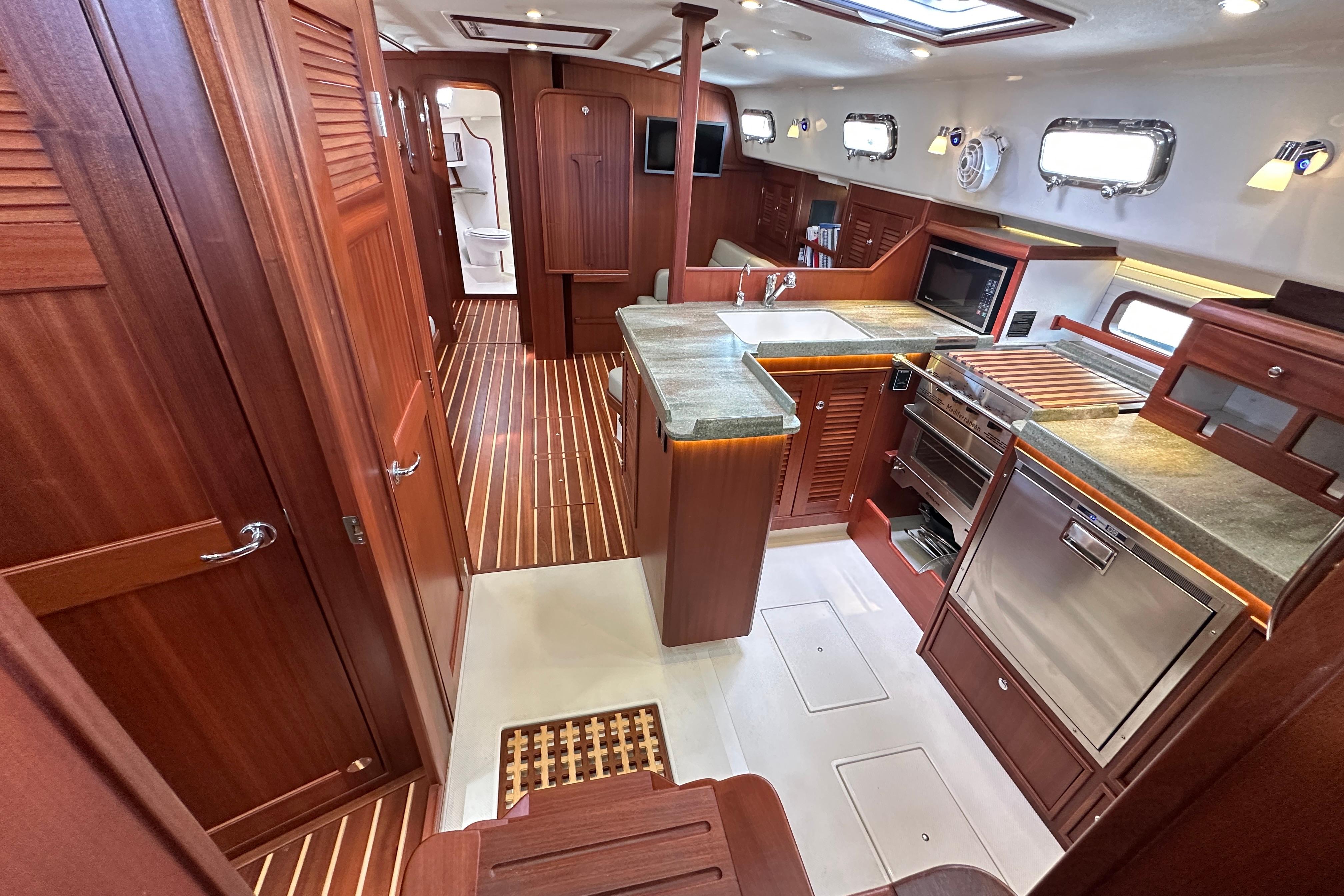 Luxurious interior of 2023 Island Packet 439 yacht with modern kitchen and wooden finishes.