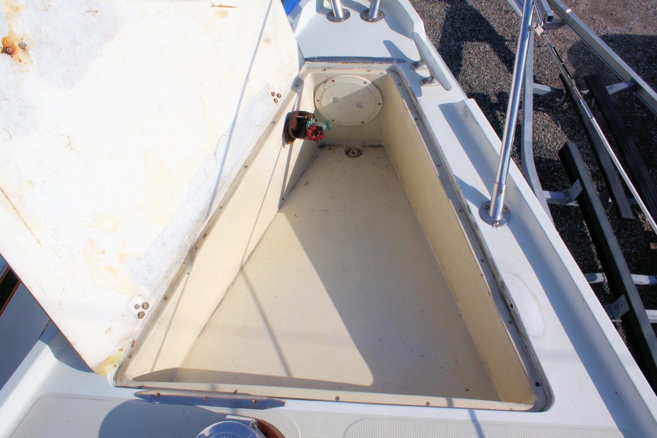 Open storage compartment on a 1987 Ericson 38-200 sailboat deck.