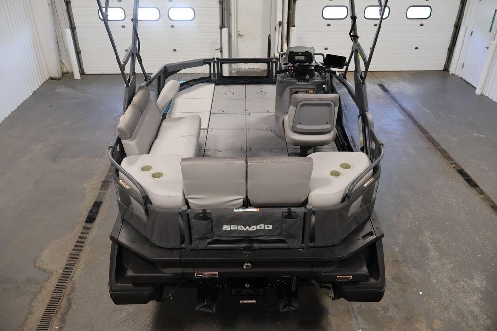 2023 Sea-Doo Switch Sport Compact boat interior with seating and controls in a garage.