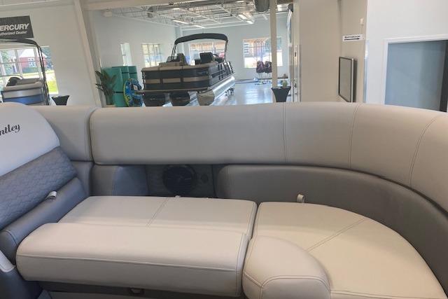 2026 Bentley Pontoons Elite 223 Swingback interior with luxurious seating in showroom.
