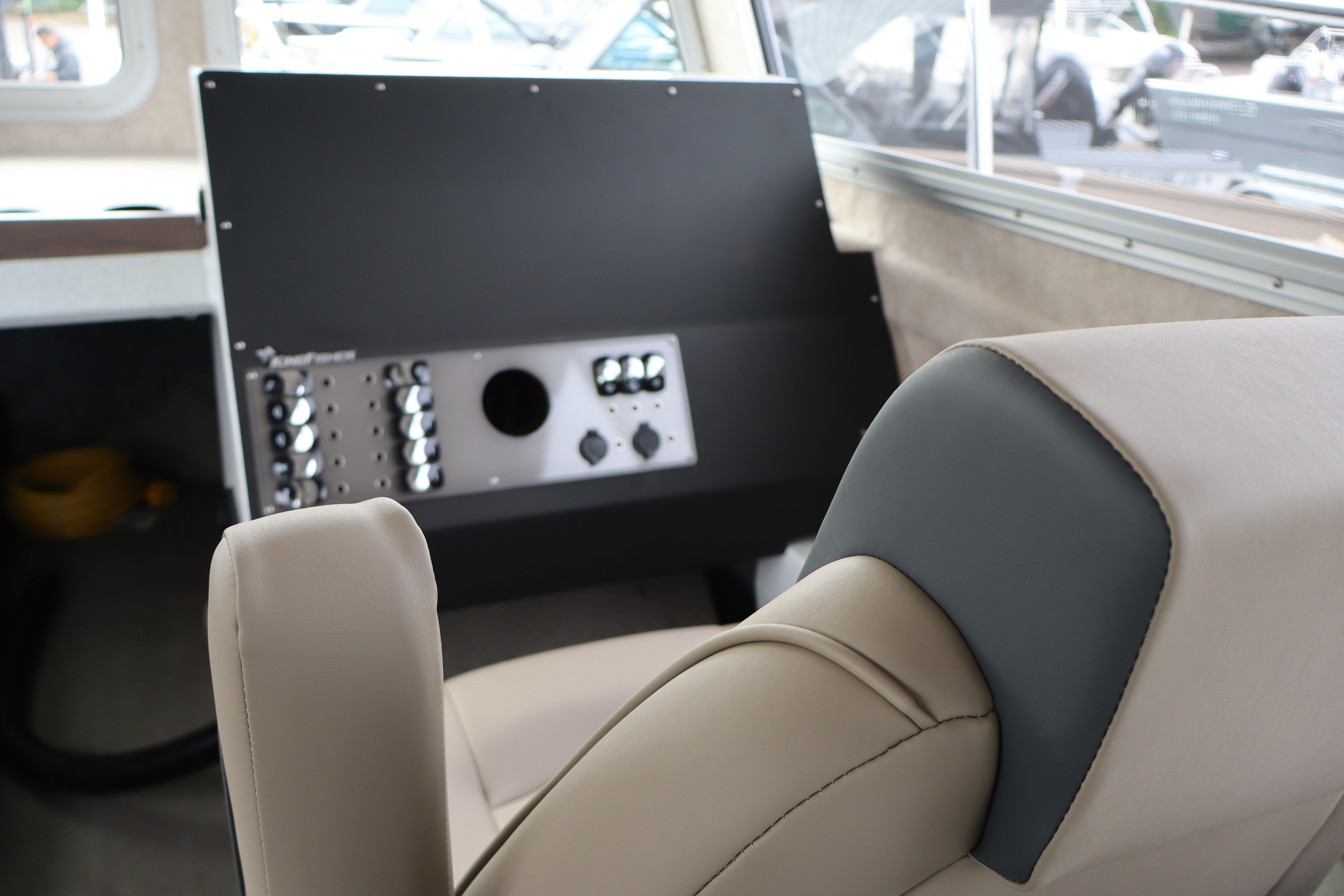Interior of 2026 KingFisher 3025 XRS boat, featuring a modern control panel and comfortable seating.