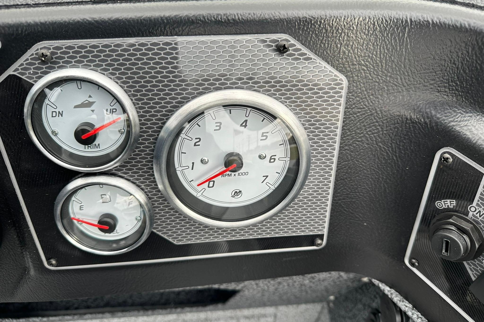 Dashboard gauges of 2026 Lund 1875 Impact XS SS boat, featuring RPM, trim, and fuel indicators.