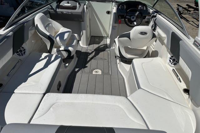 2023 Chaparral 23 SSi boat interior with white seating and modern dashboard design.