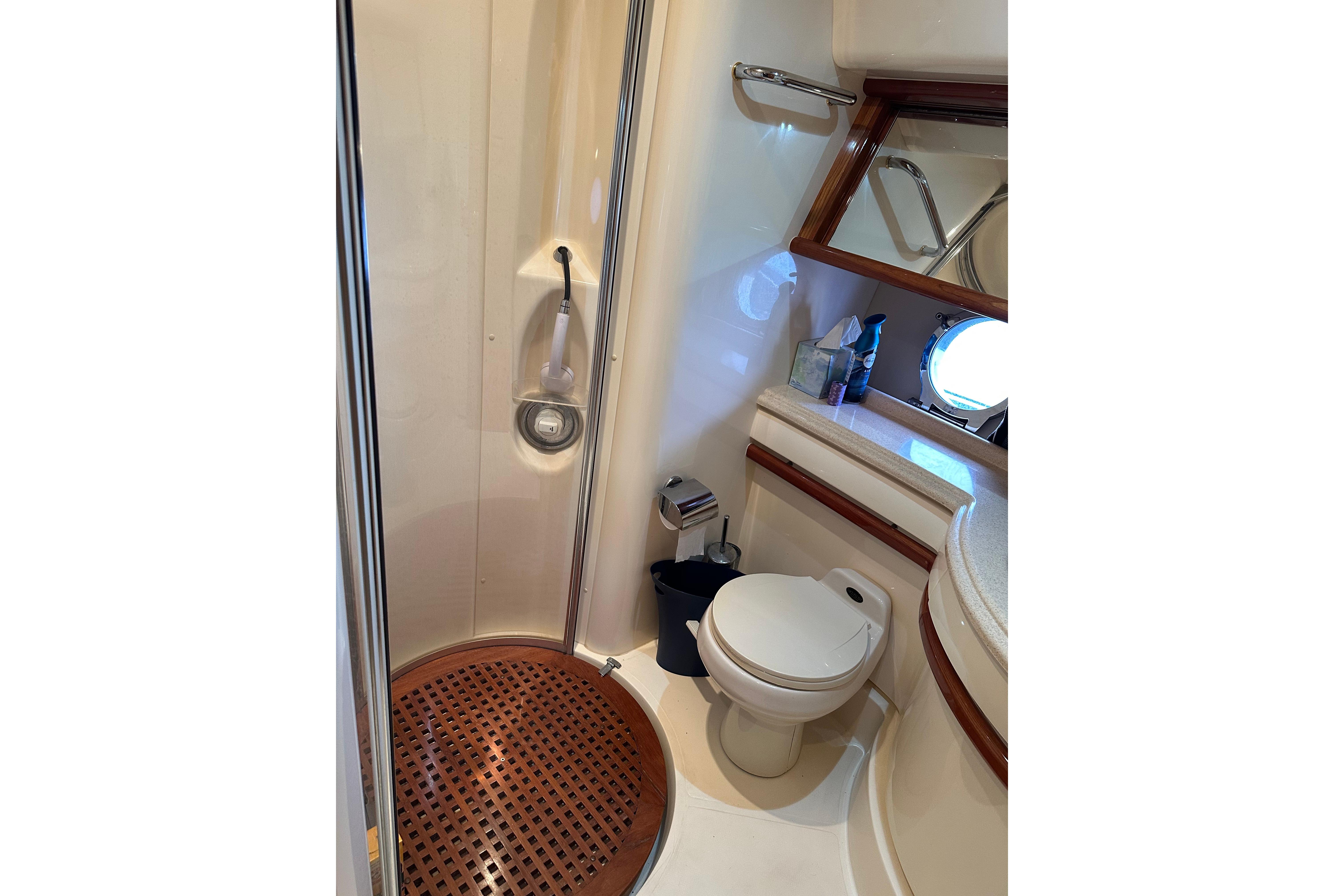 Bathroom interior of a 2004 Azimut 55E yacht, featuring shower and toilet.