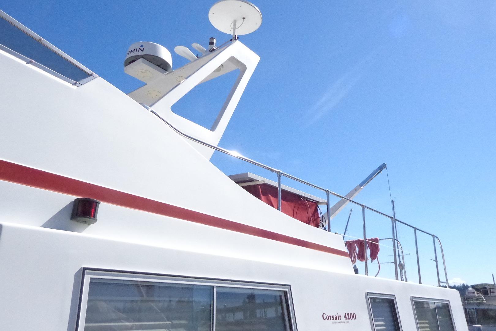 1992 Cruise-A-Home Corsair 4200 boat with radar, red accents, and clear blue sky.