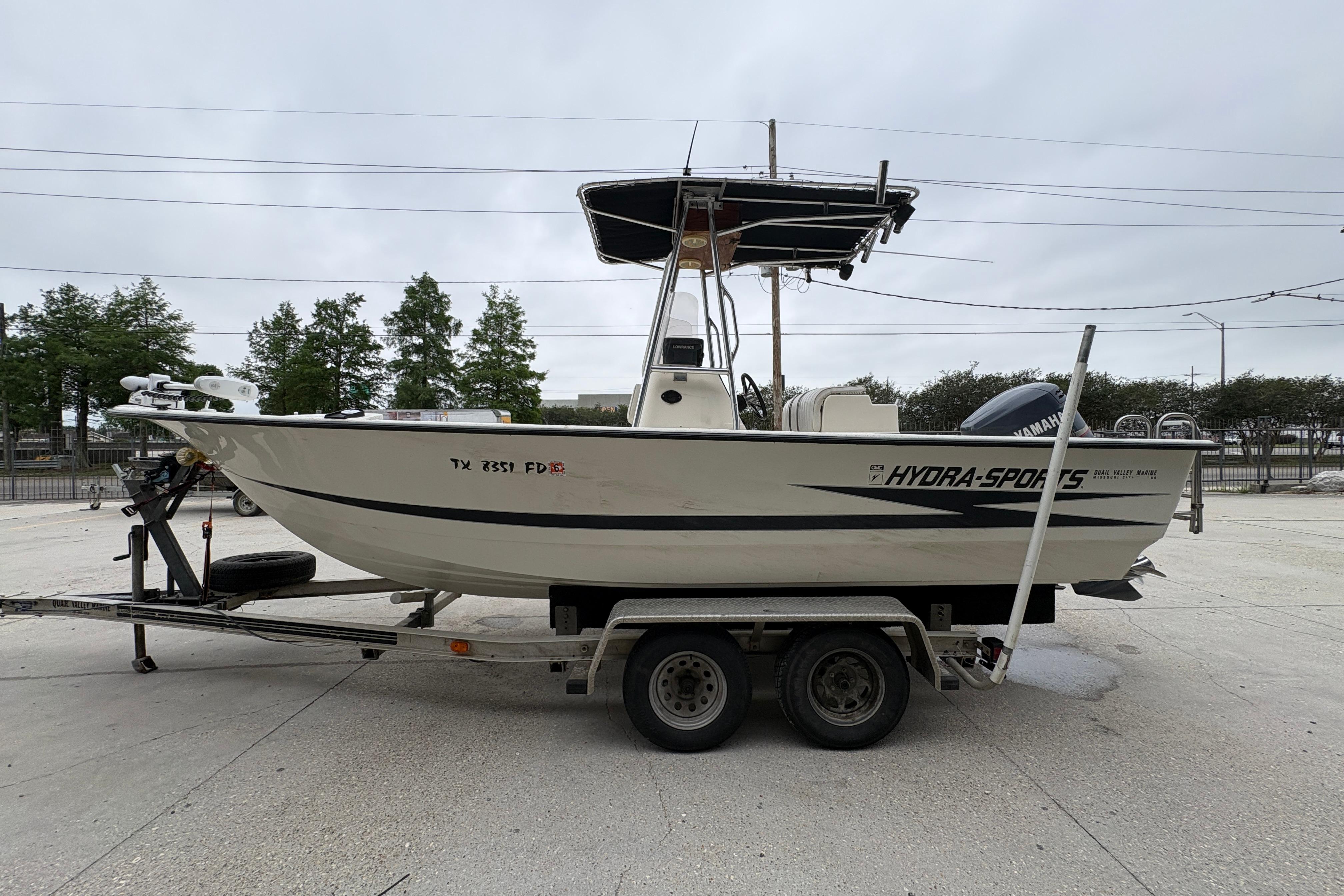 1998 Hydra-Sports 22 Ocean CC boat on trailer, side view, overcast sky.