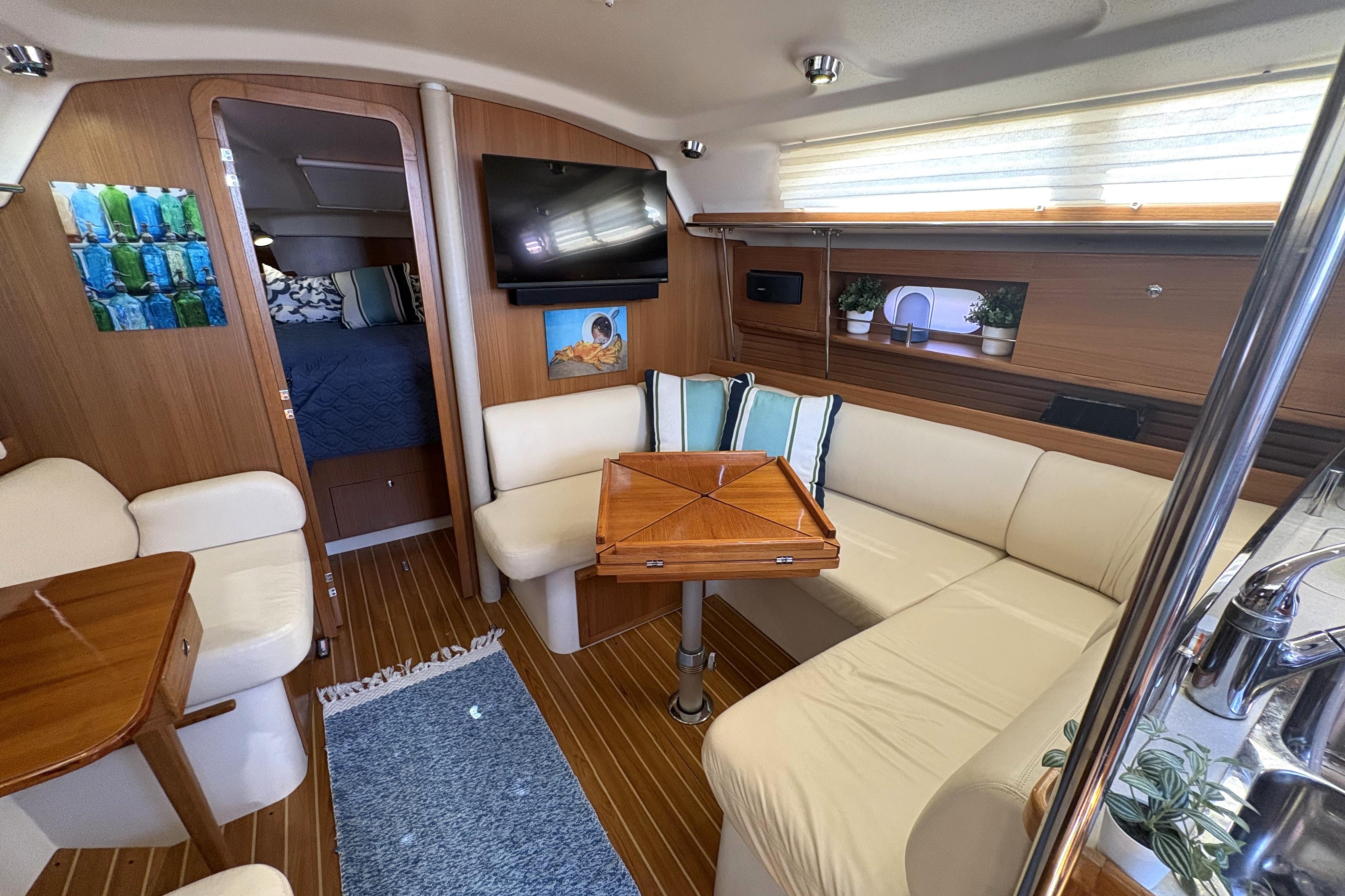 Luxurious interior of a 2011 Catalina 355 yacht with cozy seating and elegant wood finishes.