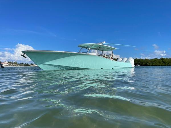 2025 Mag Bay 43 Center Console boat on clear water under blue sky.