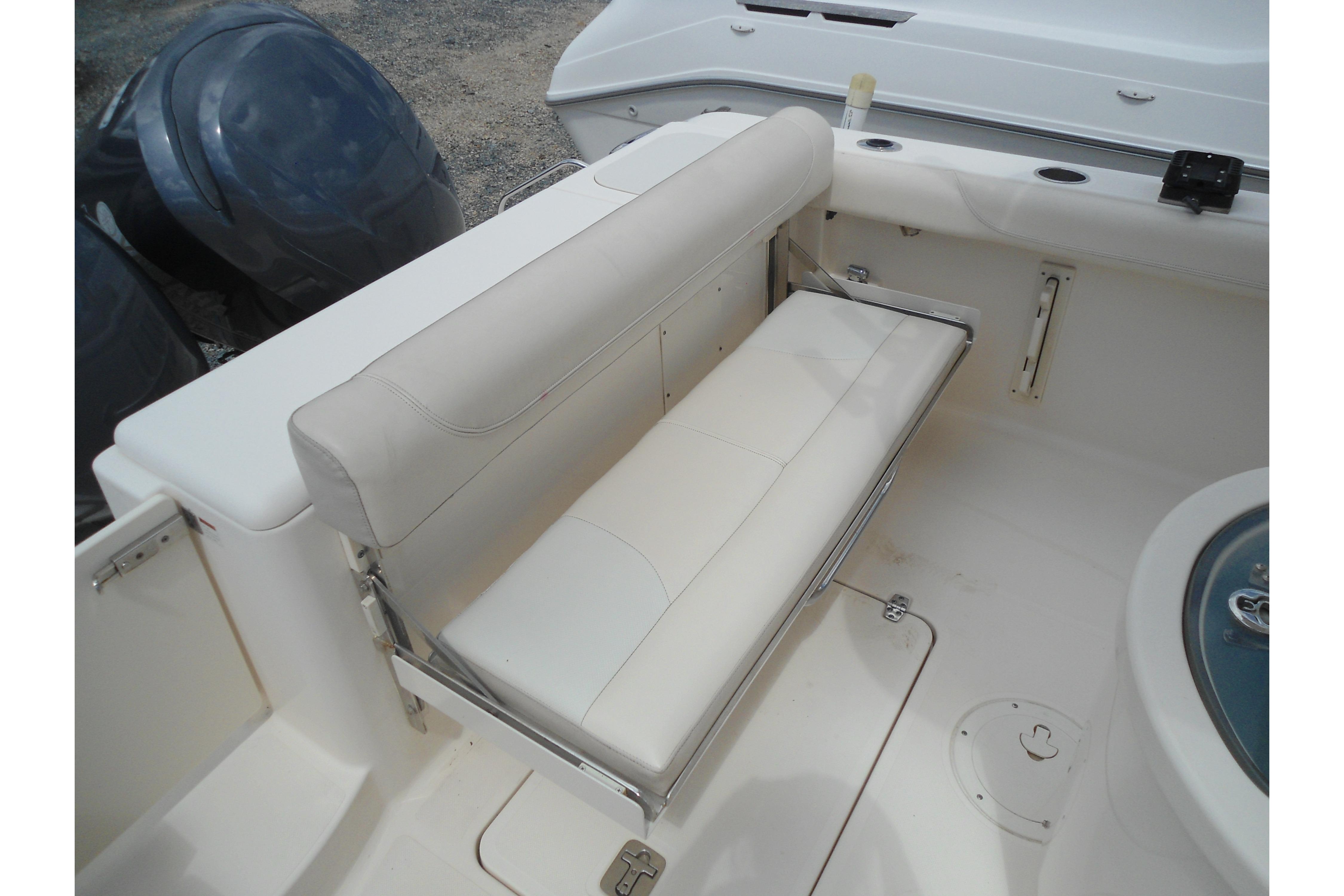 2013 Pursuit C 260 Center Console boat with foldable white bench seat.