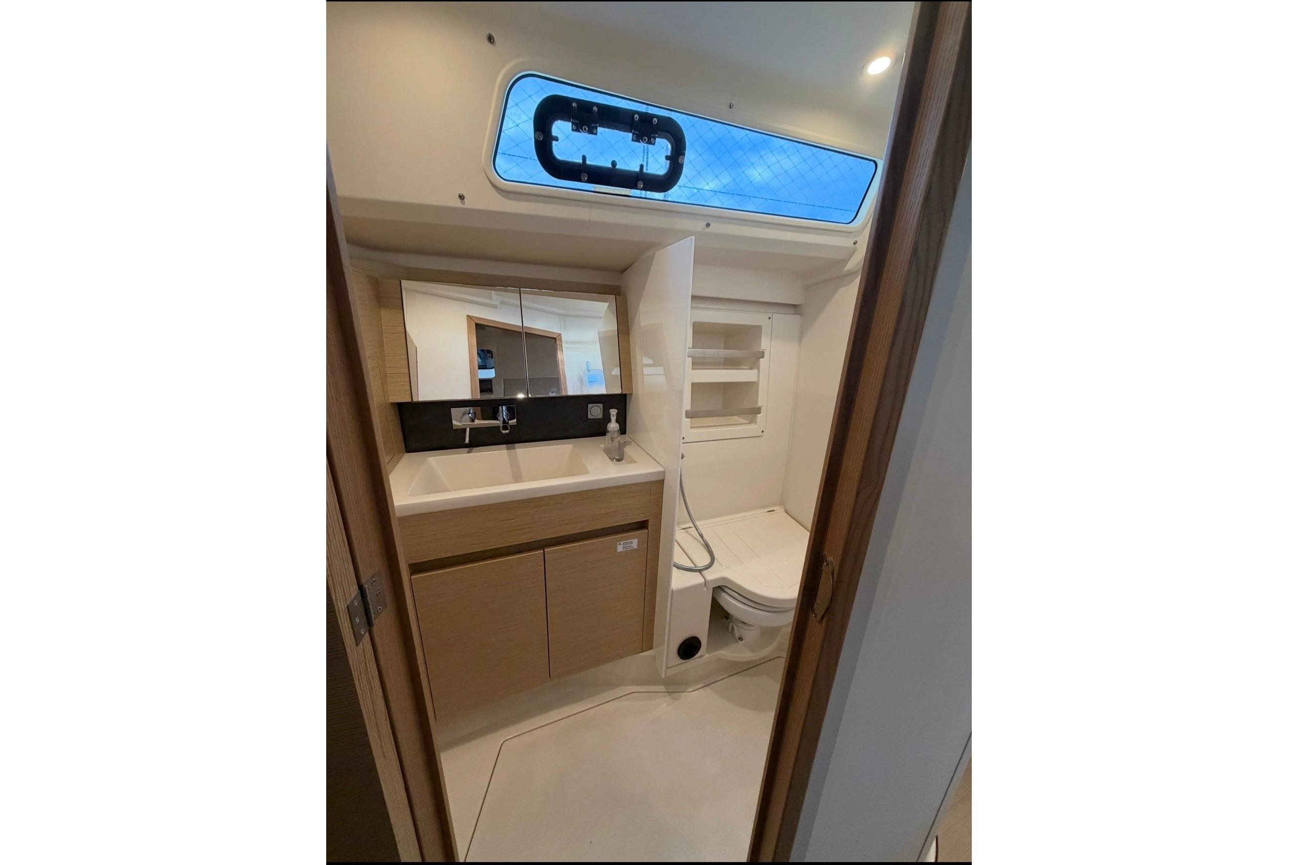 Modern bathroom interior of 2022 Hanse 418 yacht, featuring sleek design and compact amenities.