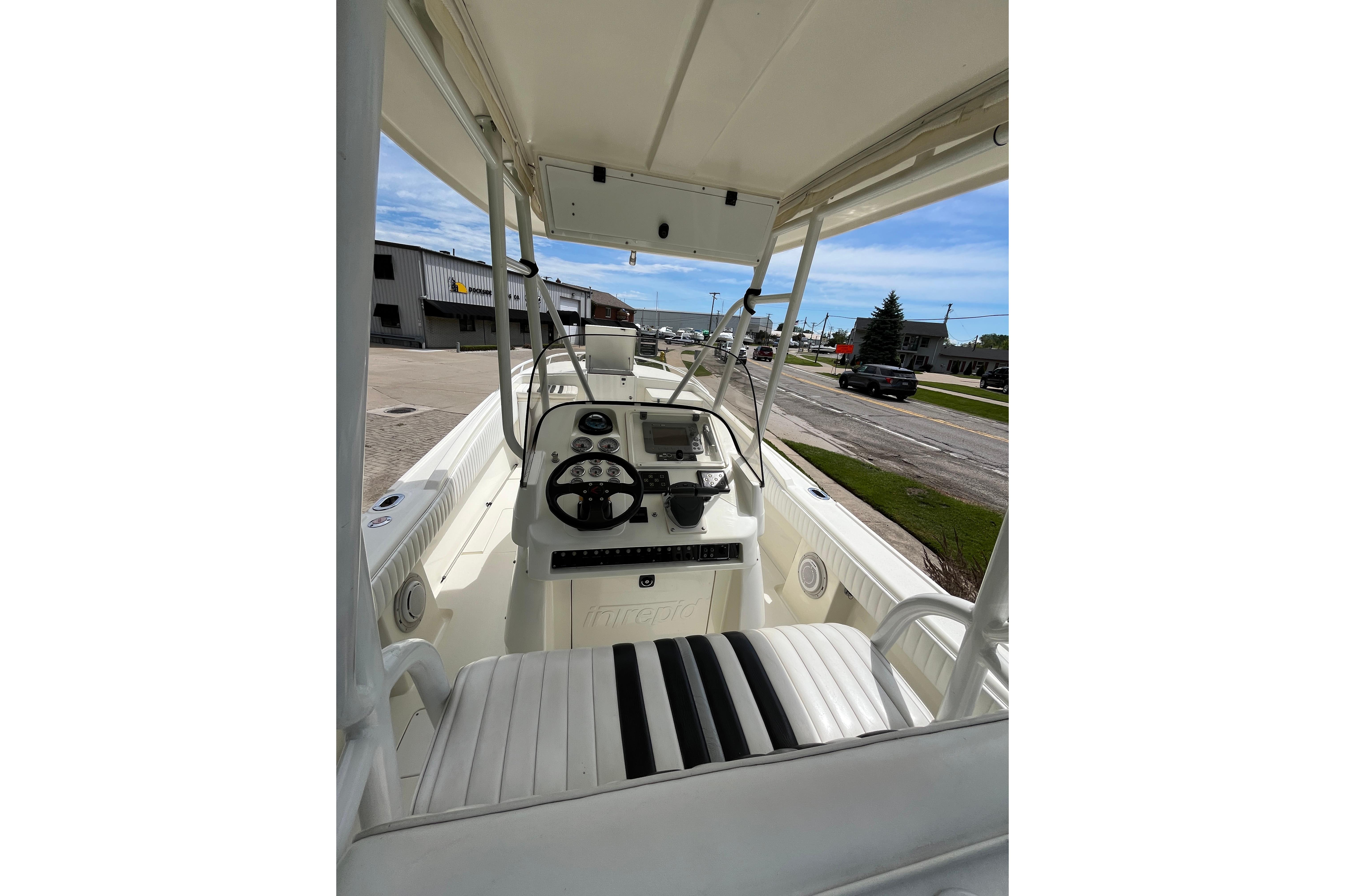 1994 Intrepid 30 Open Cuddy boat interior with steering wheel and seating.