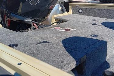 2026 Tracker Targa V-19 Combo boat interior with carpeted deck and motor.