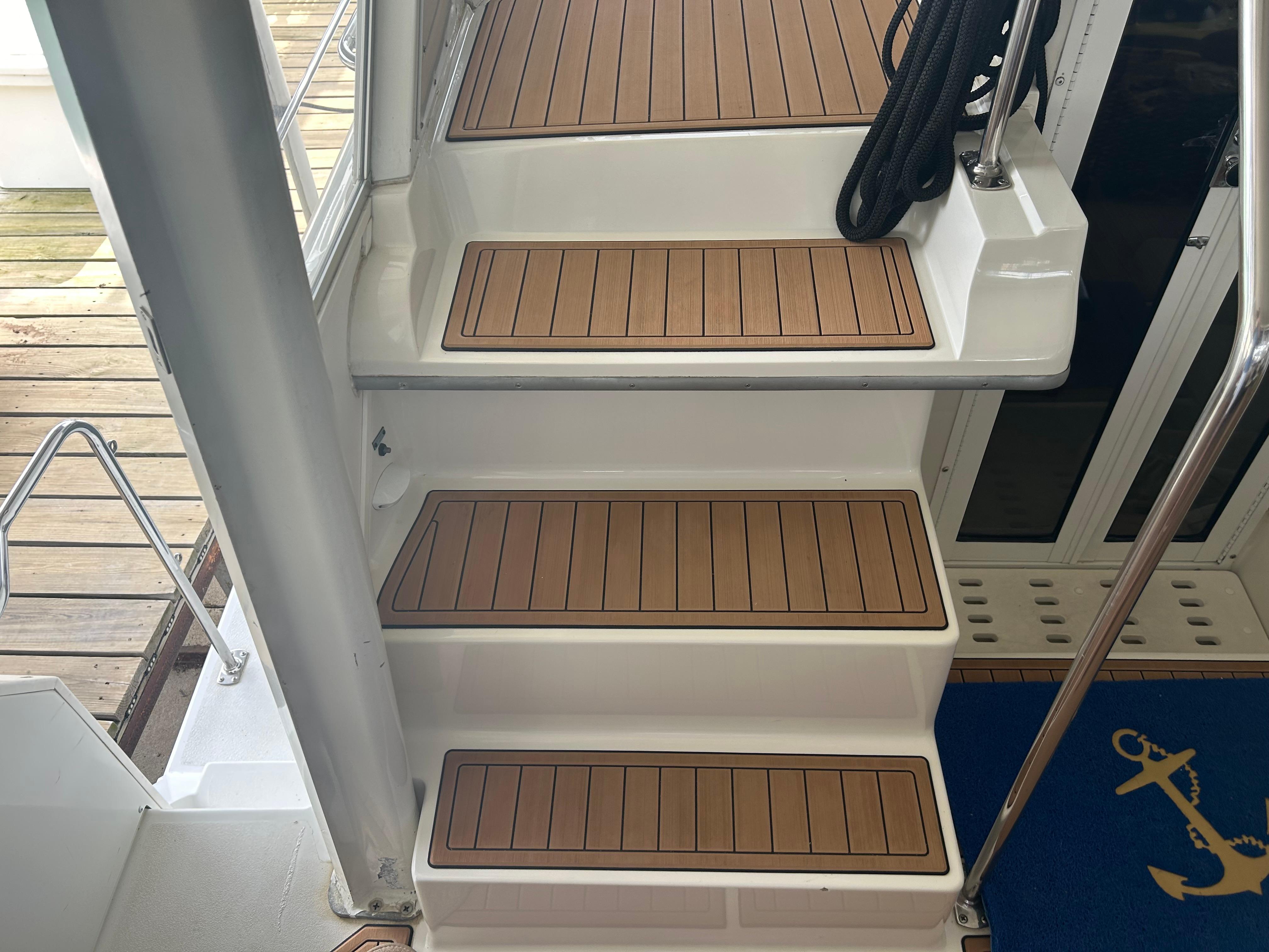 Staircase on 1996 Carver 440 Aft Cabin Motor Yacht with teak steps.