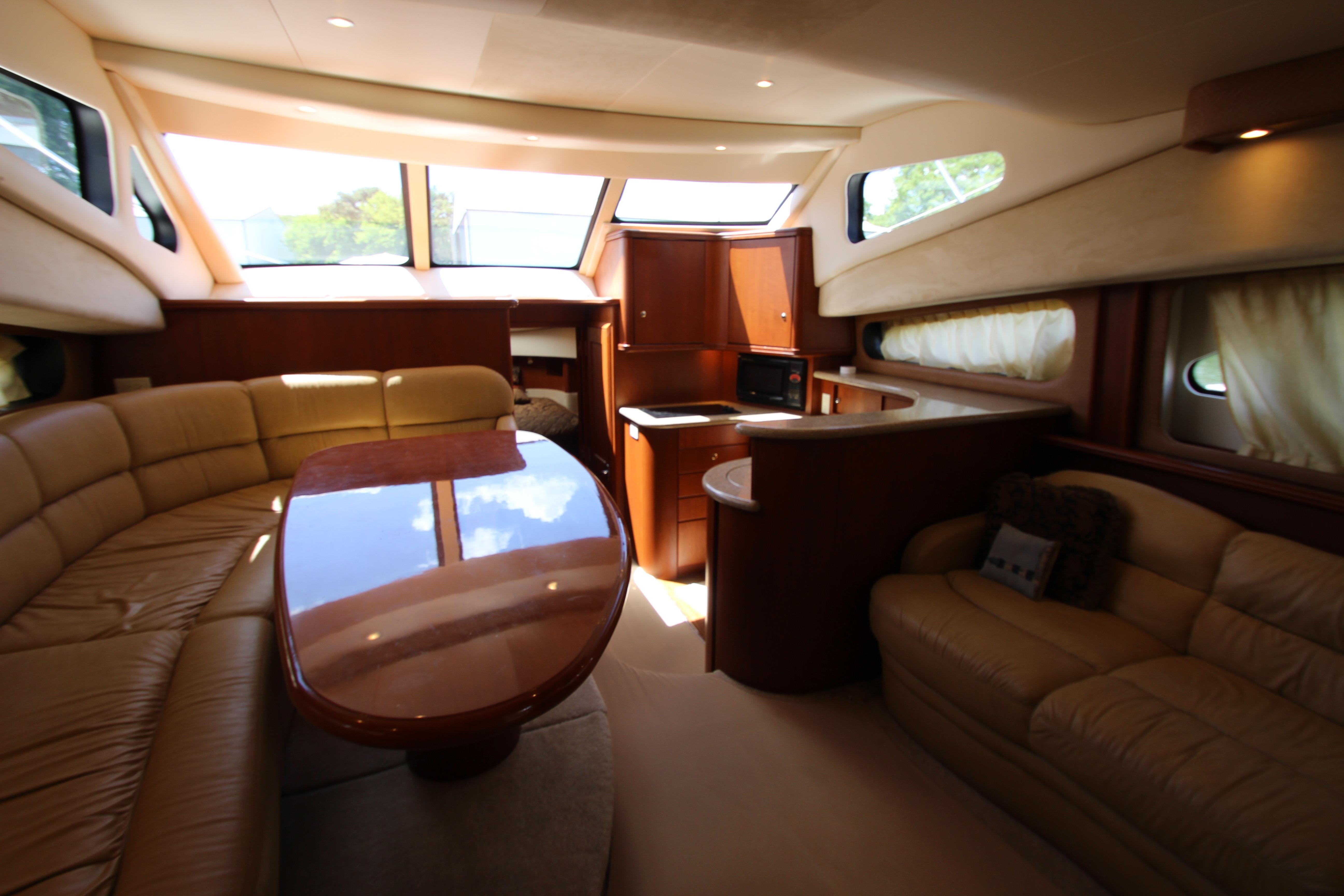 Luxurious interior of 2006 Silverton 38 Sport Bridge yacht with elegant seating and dining area.