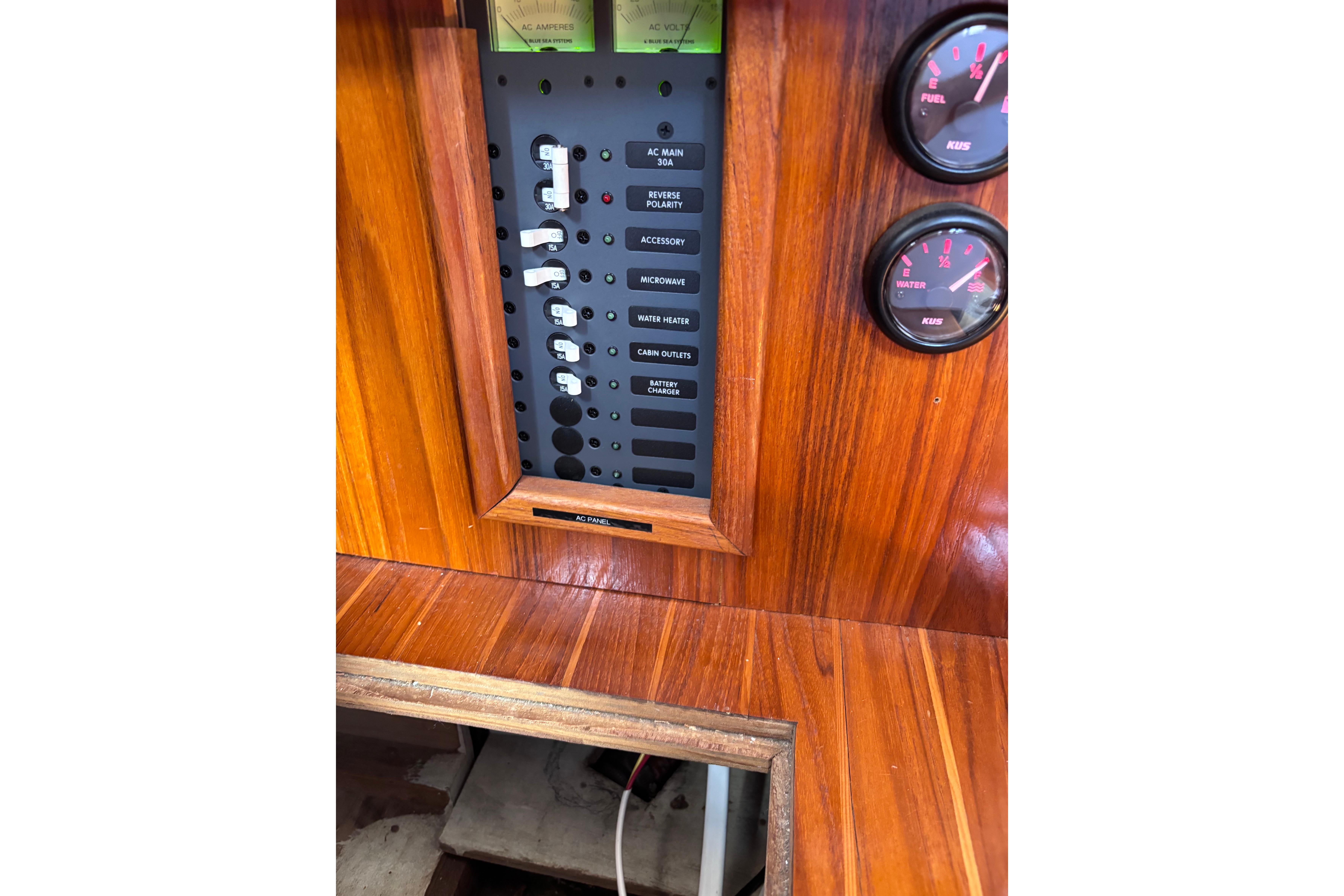 1978 Swift 33 boat control panel with gauges and switches on wooden dashboard.
