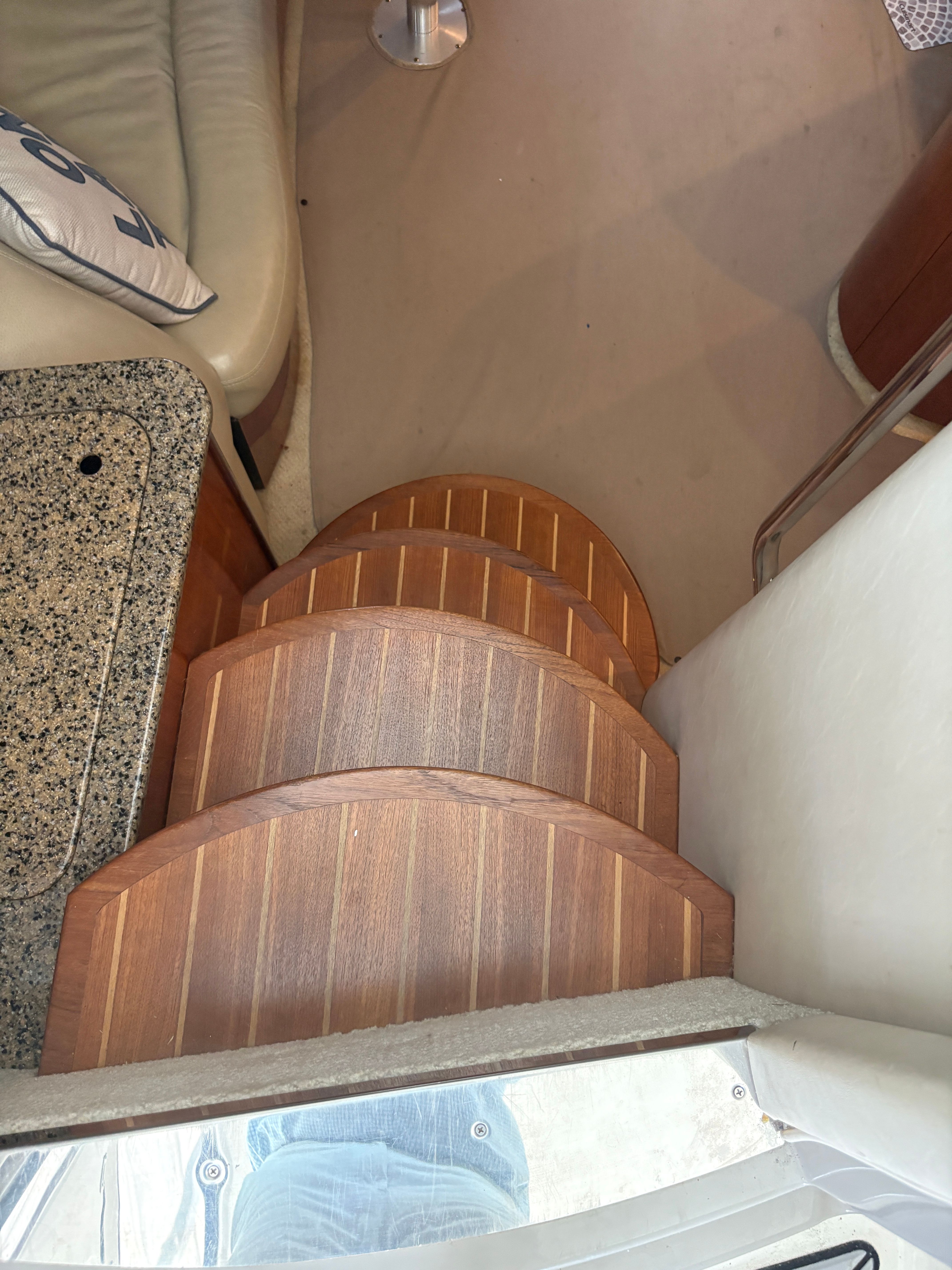 Interior of a 2005 Sea Ray 420 Sundancer with wooden steps.