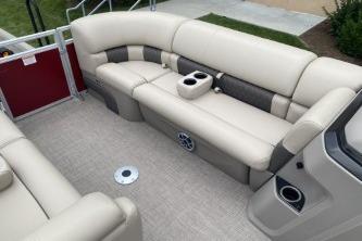 2024 Sun Tracker Party Barge 22 DLX interior with beige seating and cup holders.
